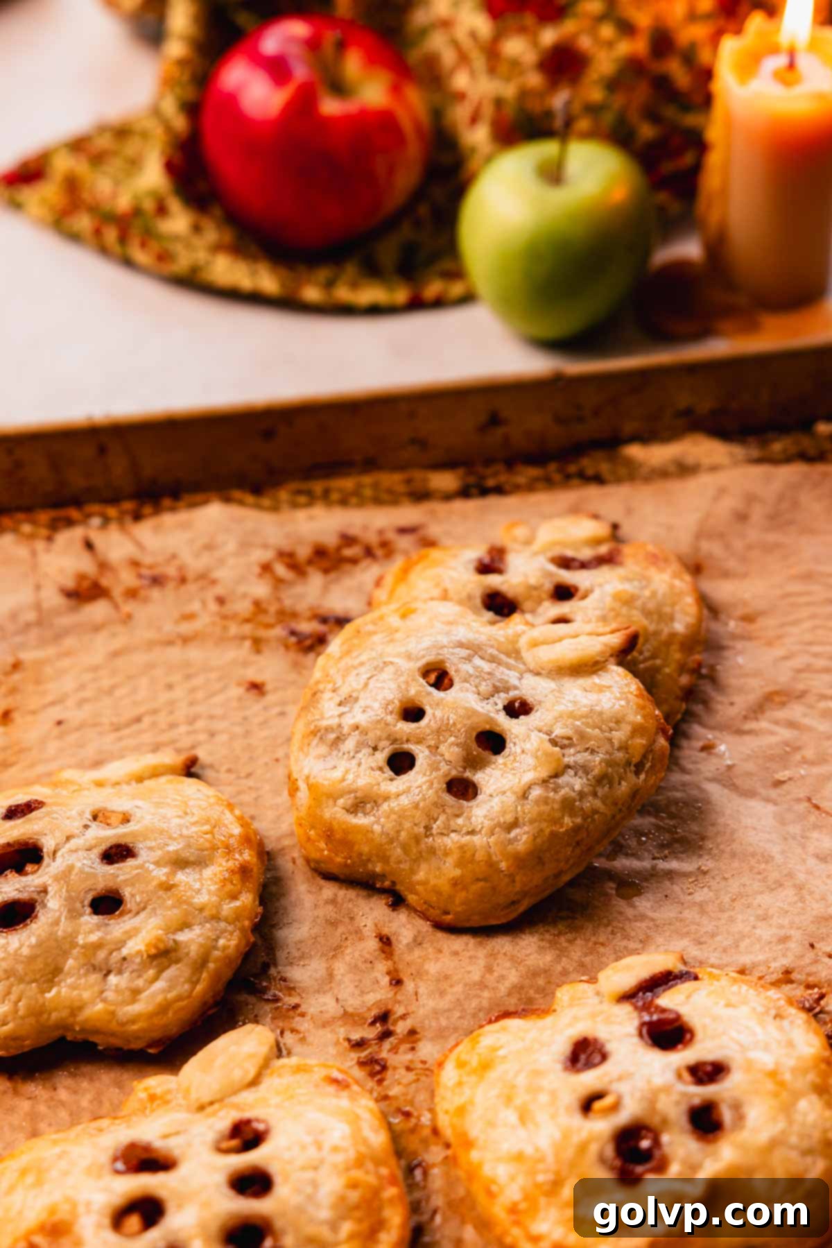 Beautifully arranged apple shaped hand pies on a baking sheet