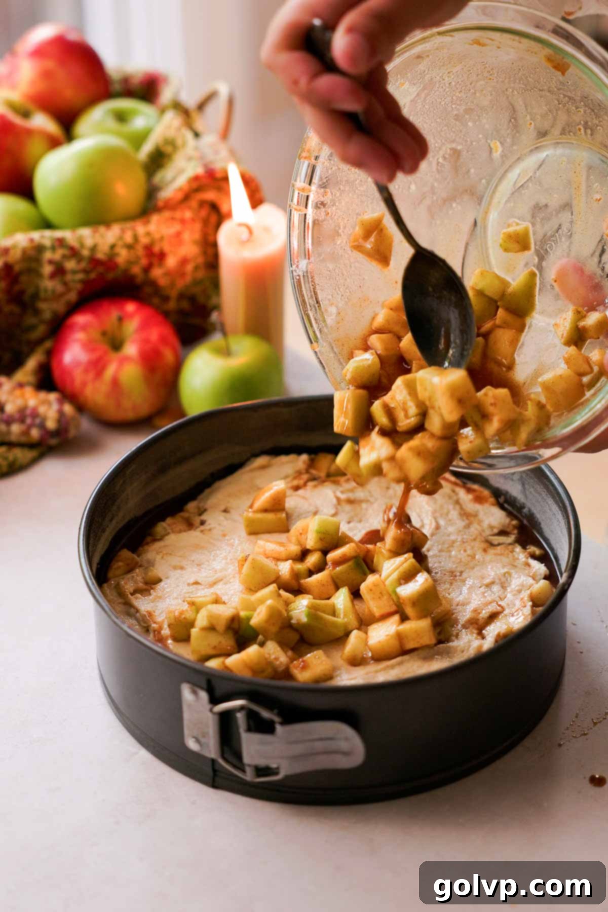 pouring remaining chopped apple filling on top of apple fritter cake