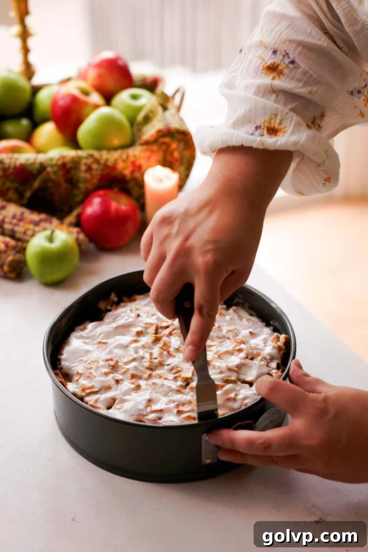running a metal spatula around the inside of a round springform pan
