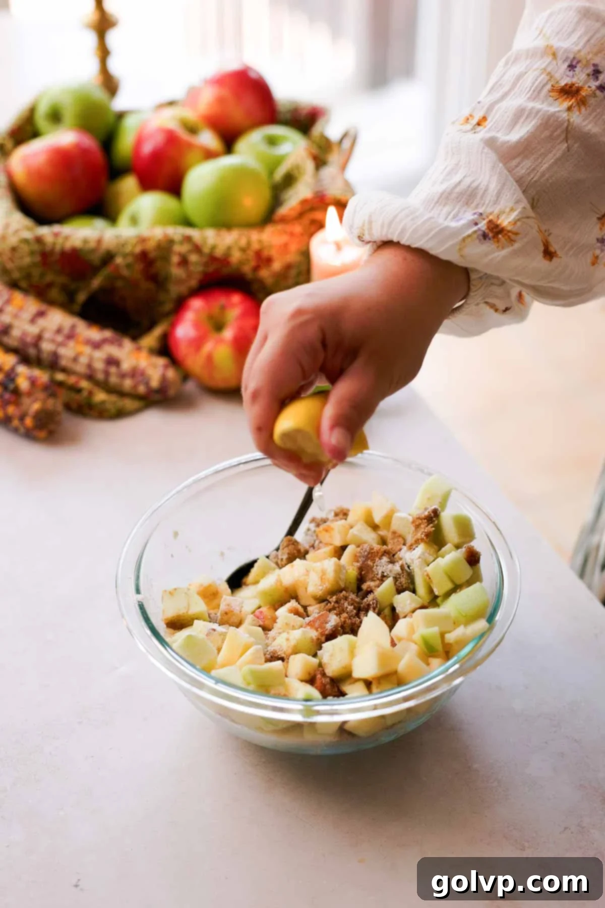 squeezing lemon juice into apple fritter cake filling