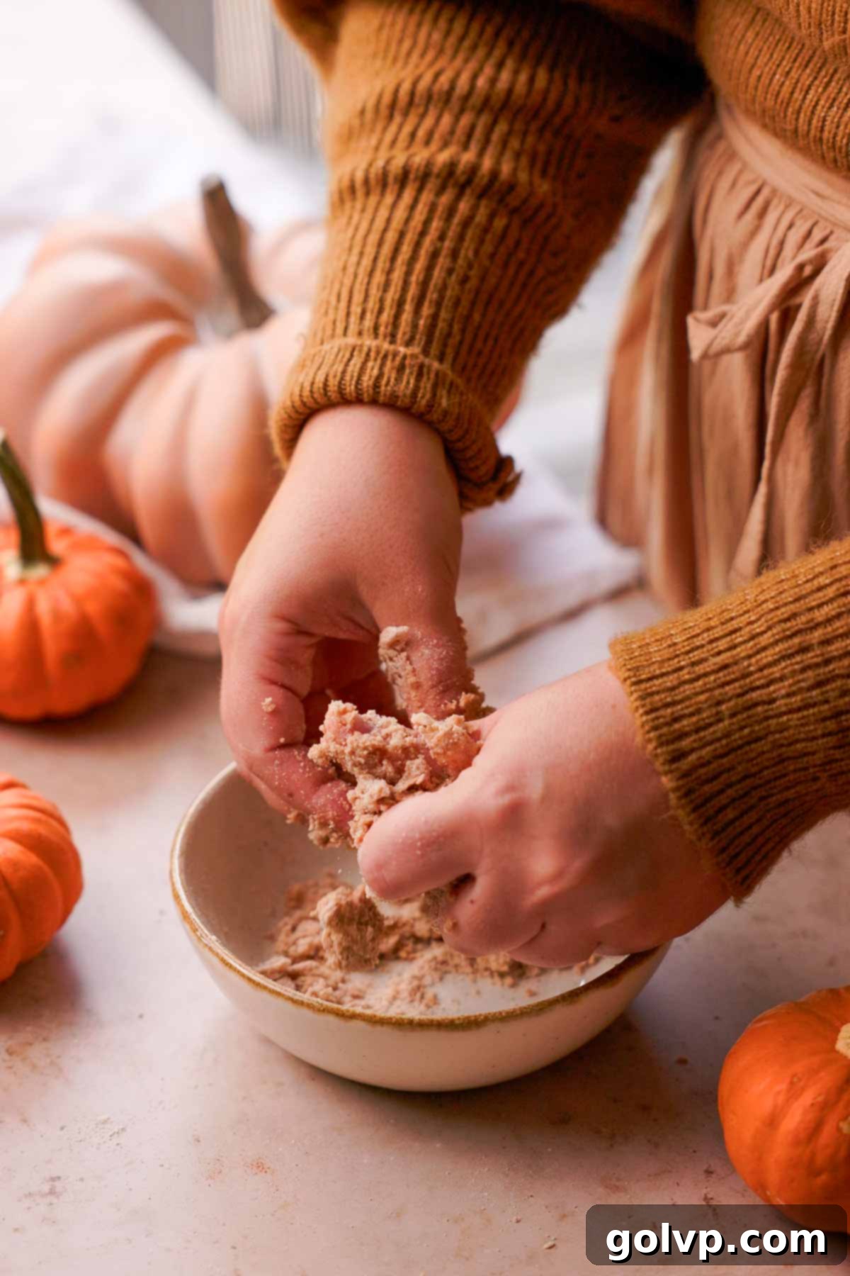 Autumn Pumpkin Streusel Cream Cheese Delight 12 mixing cinnamon streusel with fingers