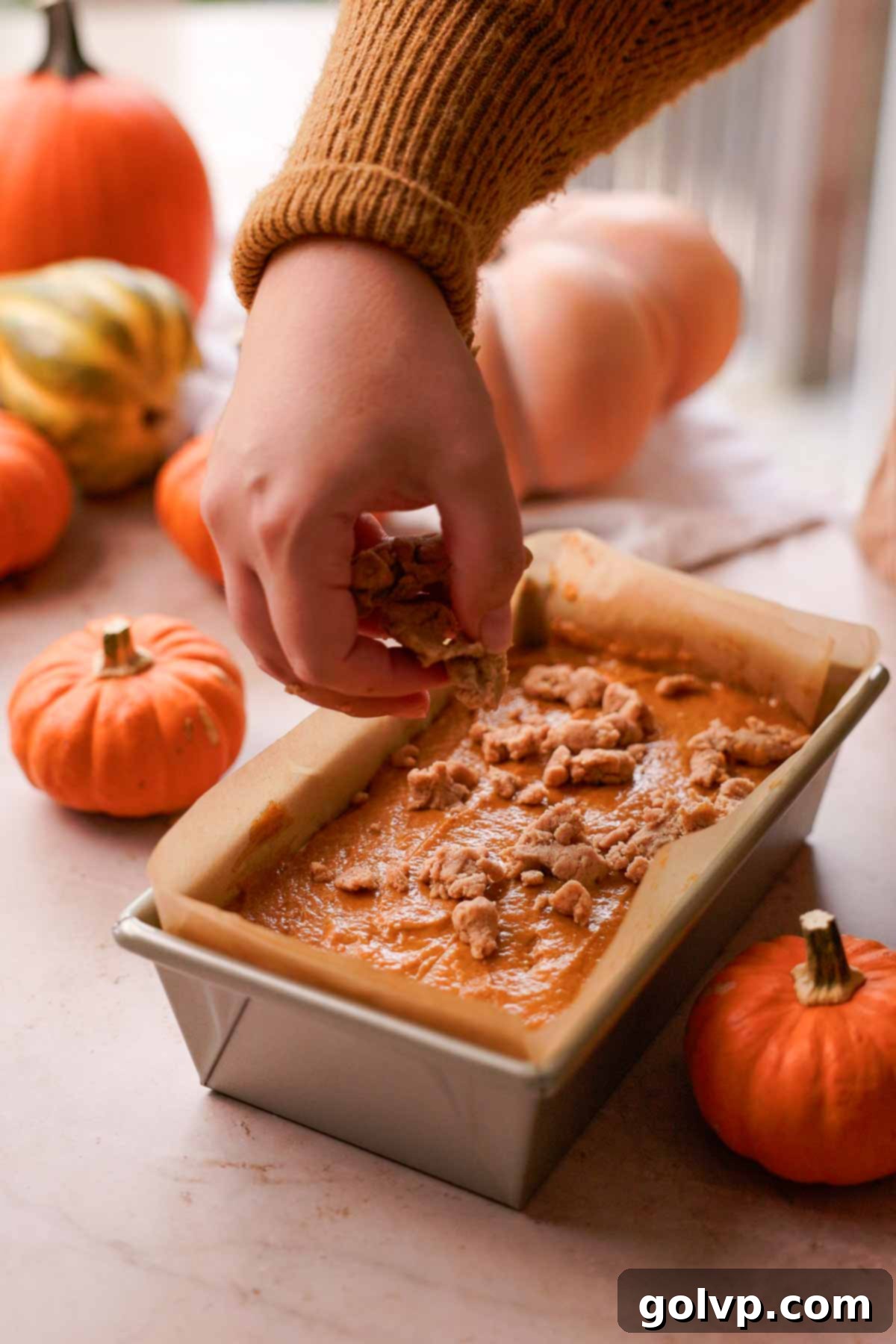 Autumn Pumpkin Streusel Cream Cheese Delight 13 sprinkling streusel over pumpkin bread batter