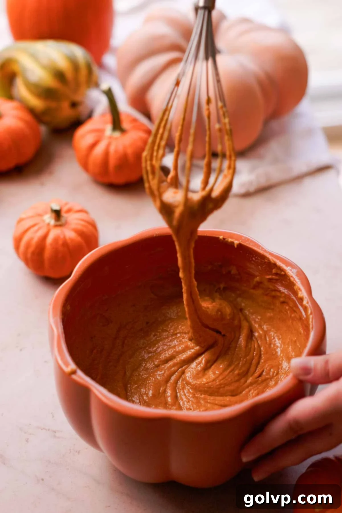 Autumn Pumpkin Streusel Cream Cheese Delight 7 pumpkin bread batter falling off a whisk