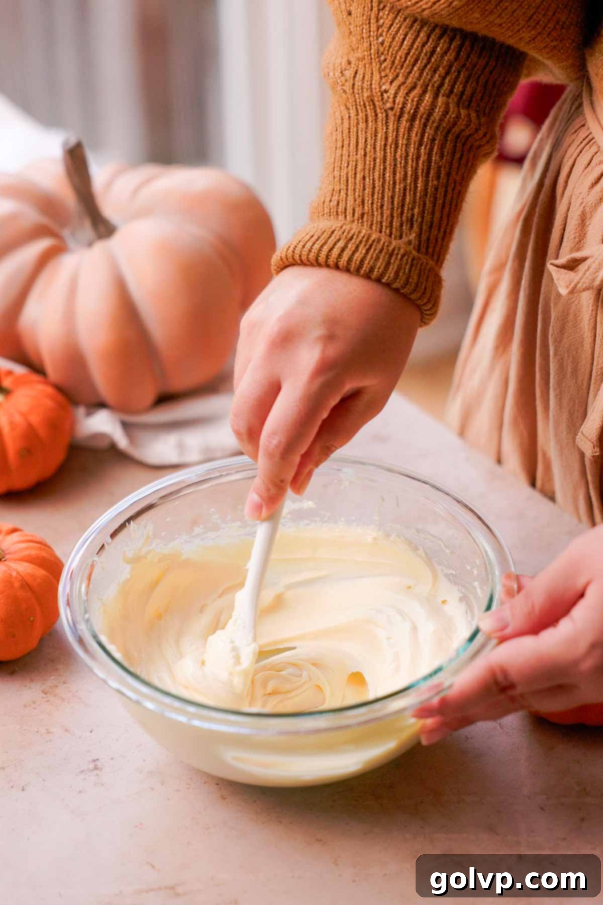 Autumn Pumpkin Streusel Cream Cheese Delight 9 stirring cream cheese batter with spoon