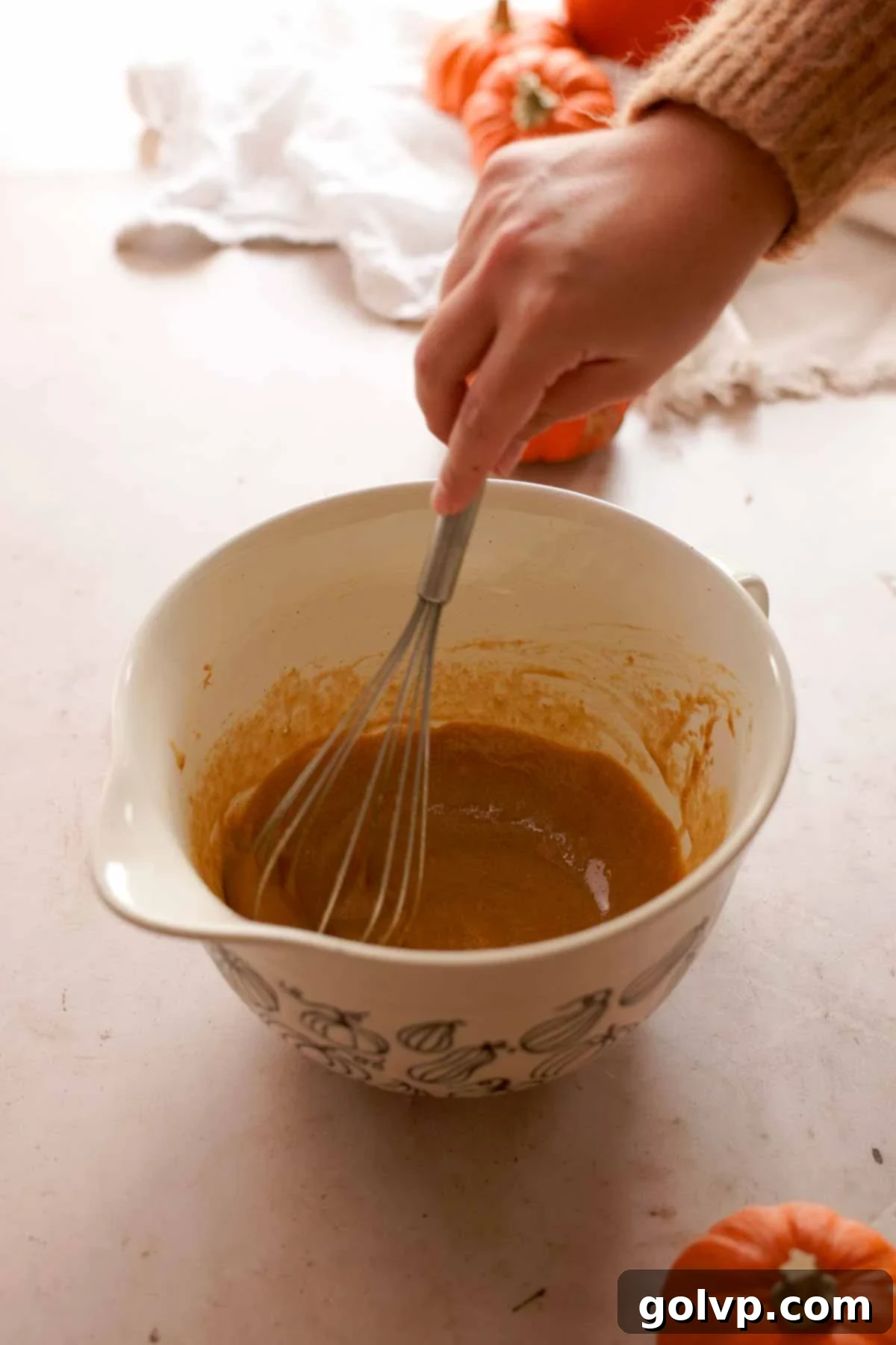 whisking eggs and sugar with a wire whisk