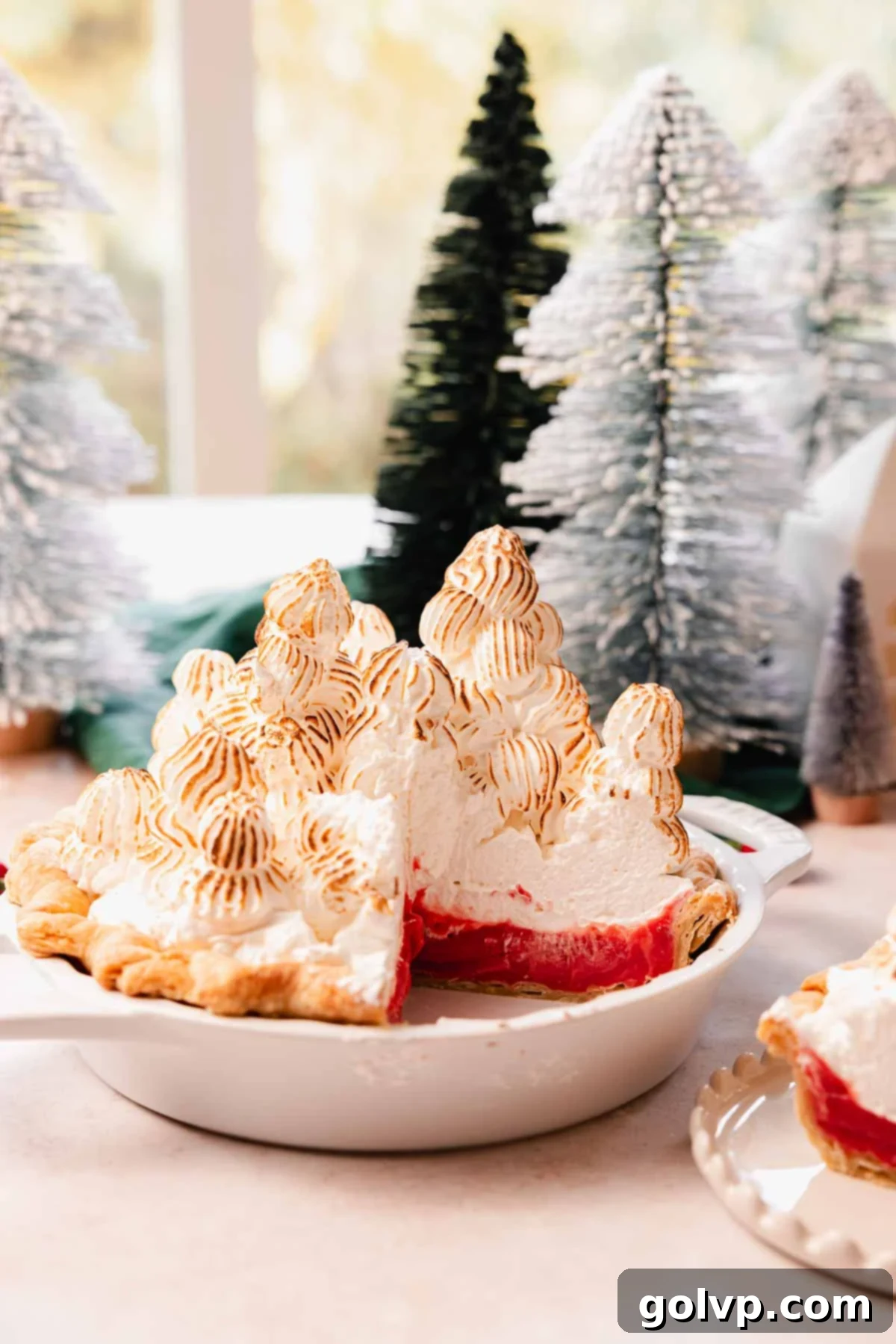 cherry meringue pie with slice cut out