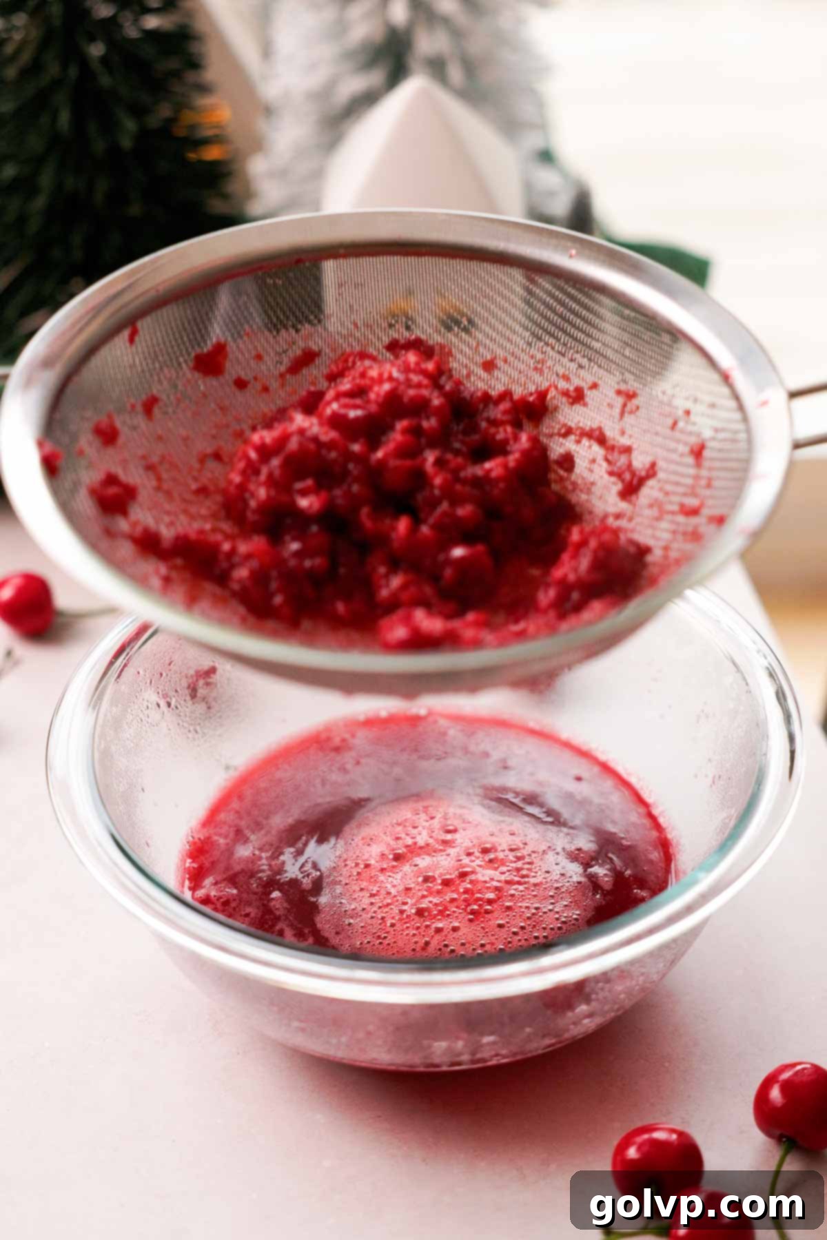 straining cherries through mesh sieve