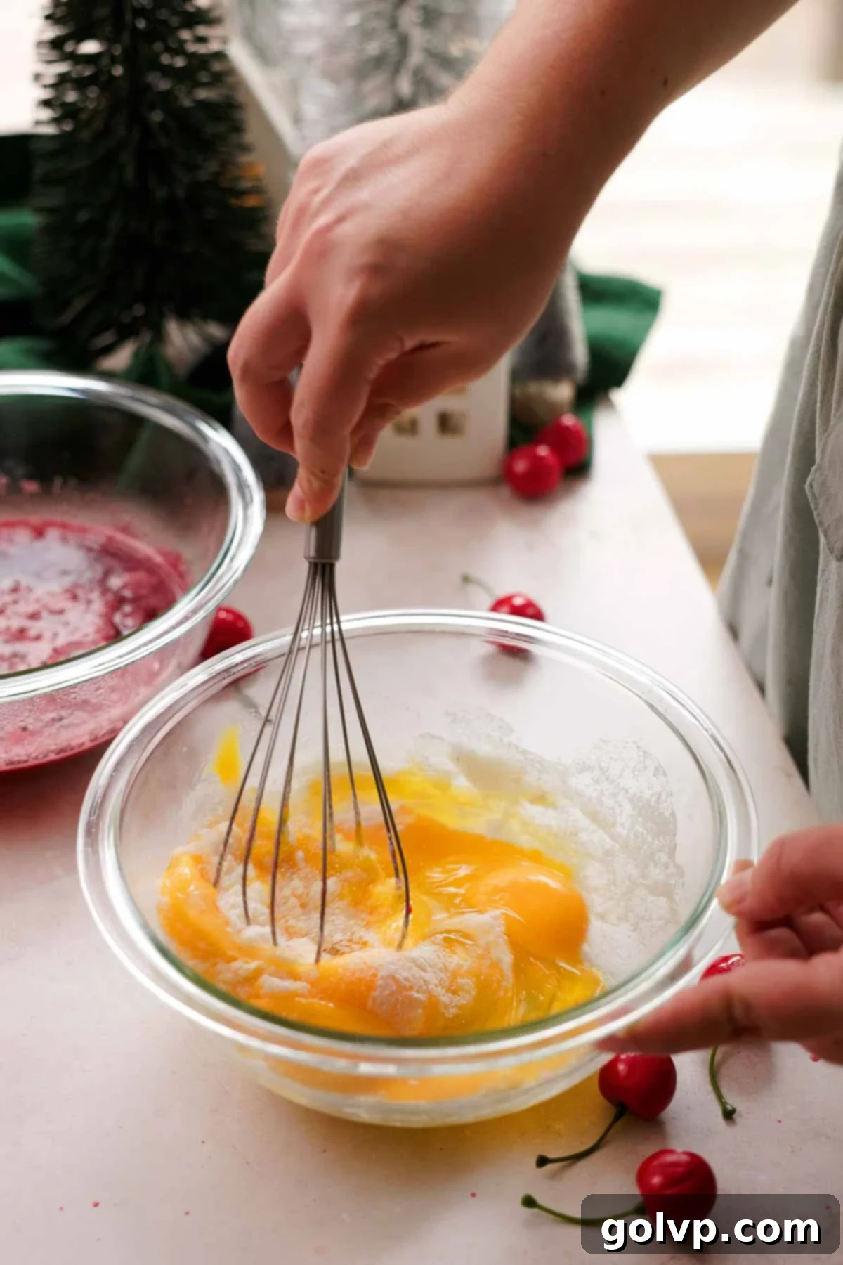 whisking eggs, sugar, and cornstarch in glass bowl