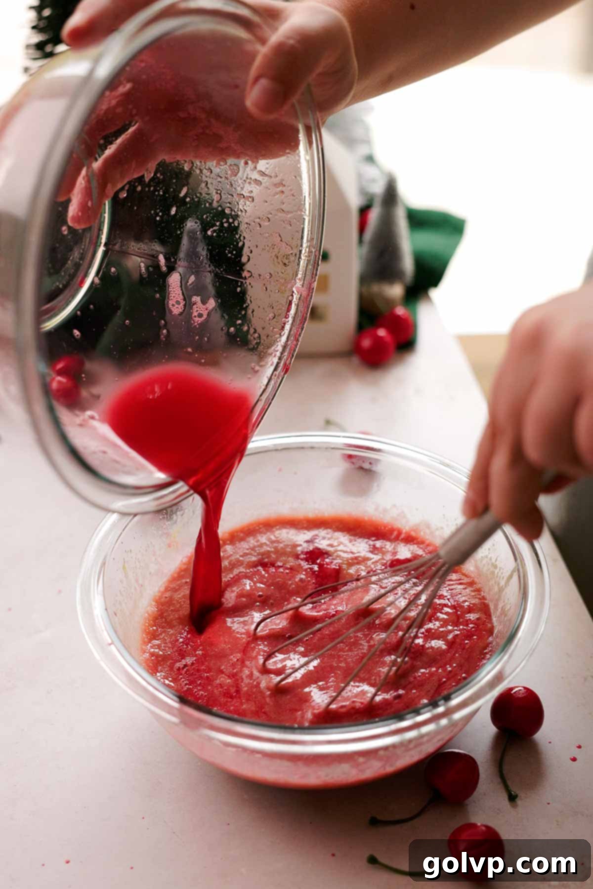 pouring hot sugar syrup into whisked eggs