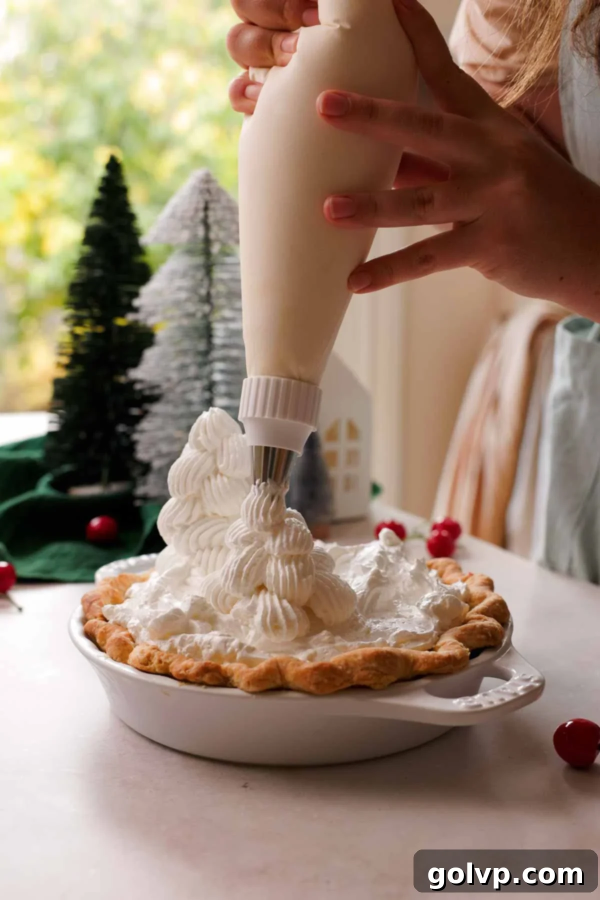 piping tall meringue trees onto cherry meringue pie