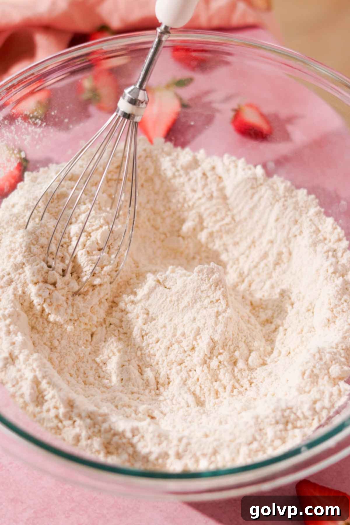 whisking dry ingredients together in large glass bowl