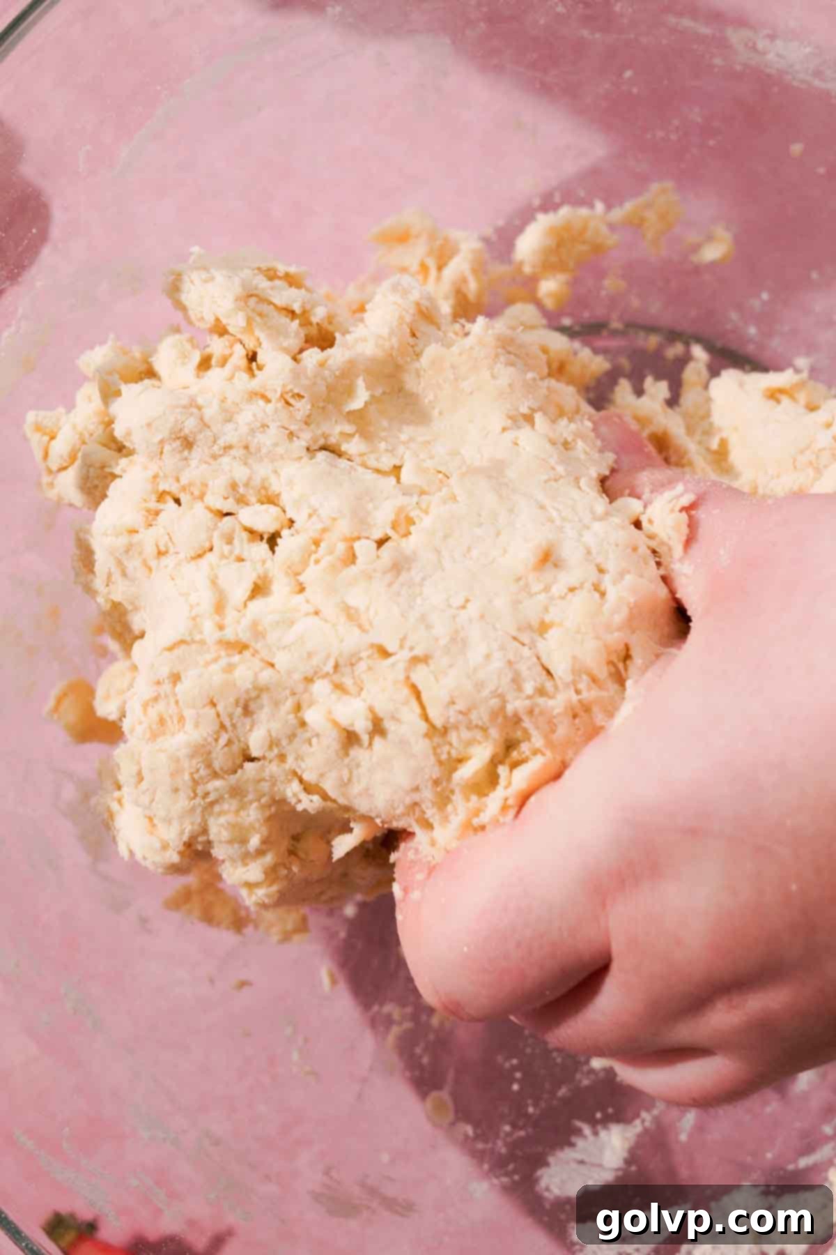 pressing dough together with hands