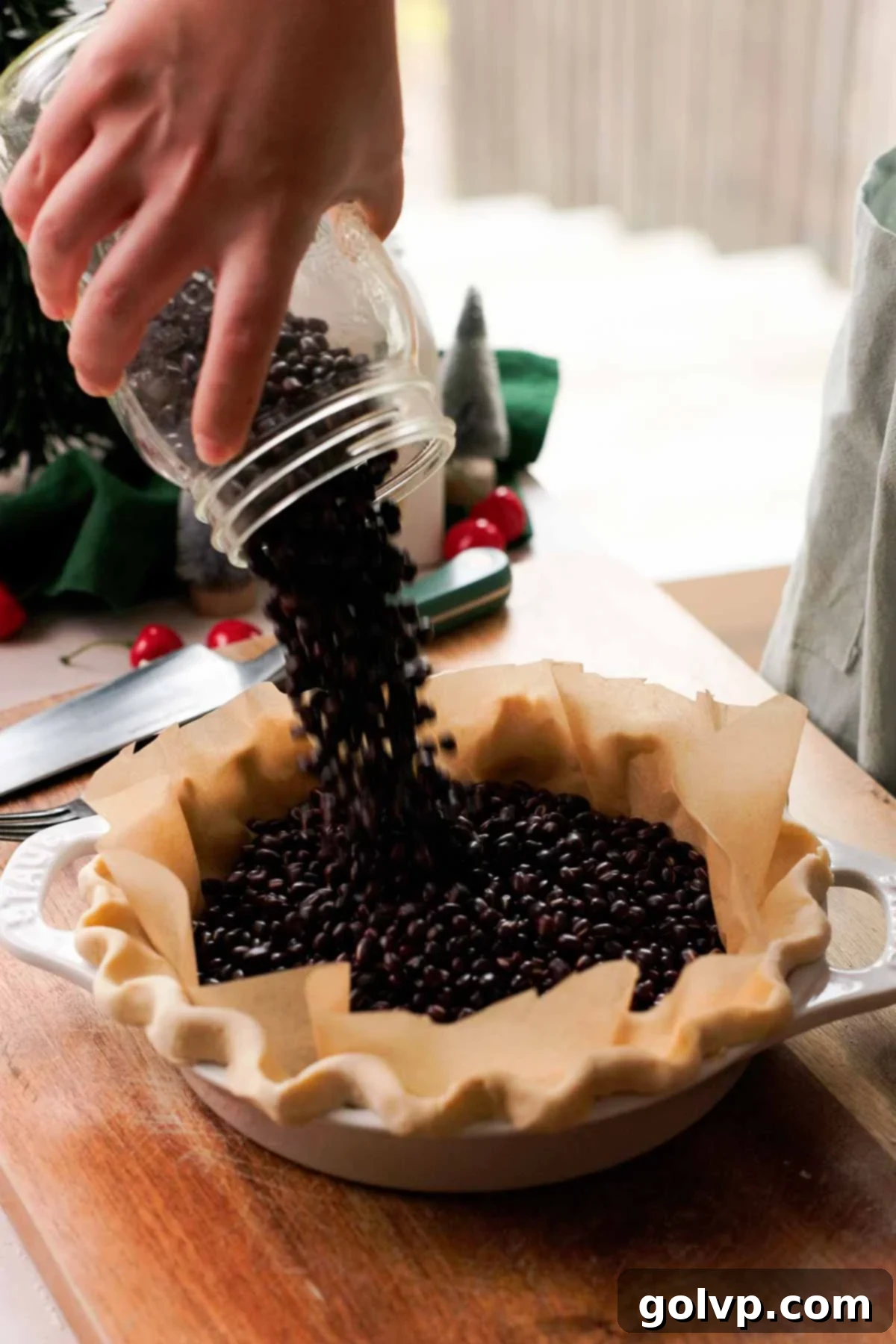 pouring beans into pie crust
