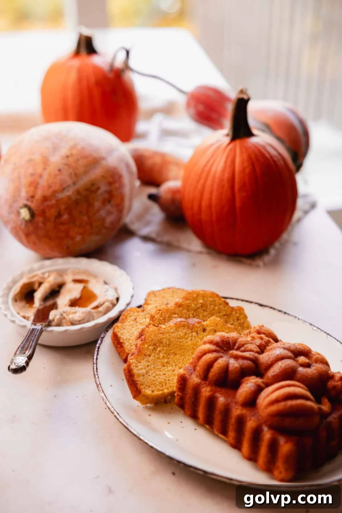 sliced cornbread loaf with whipped cinnamon honey butter and pumpkins