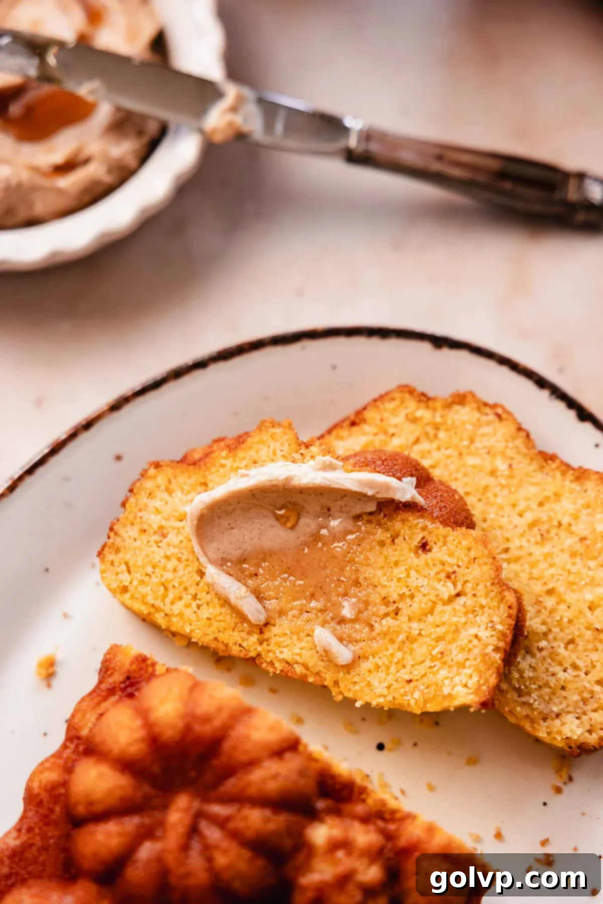 slices of cornbread loaf with cinnamon honey butter smear