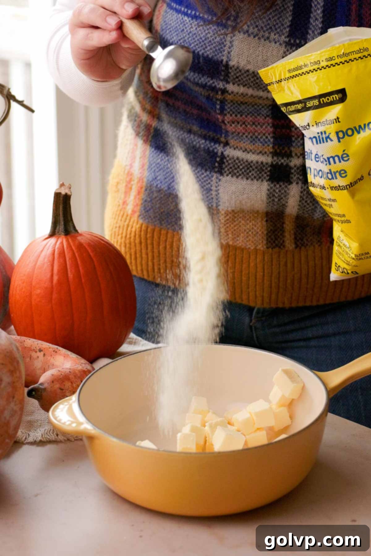 combining butter and milk powder in saucepan