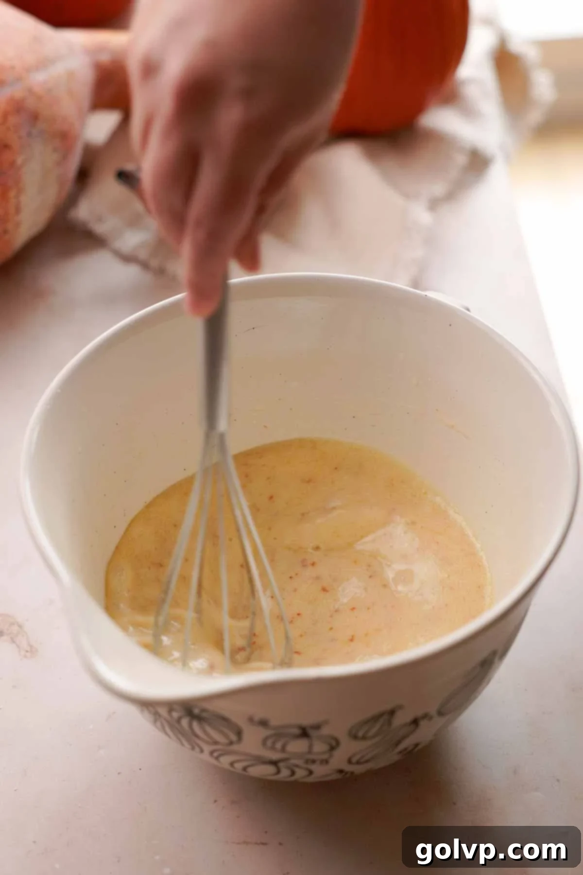 whisking cornbread wet ingredients in bowl