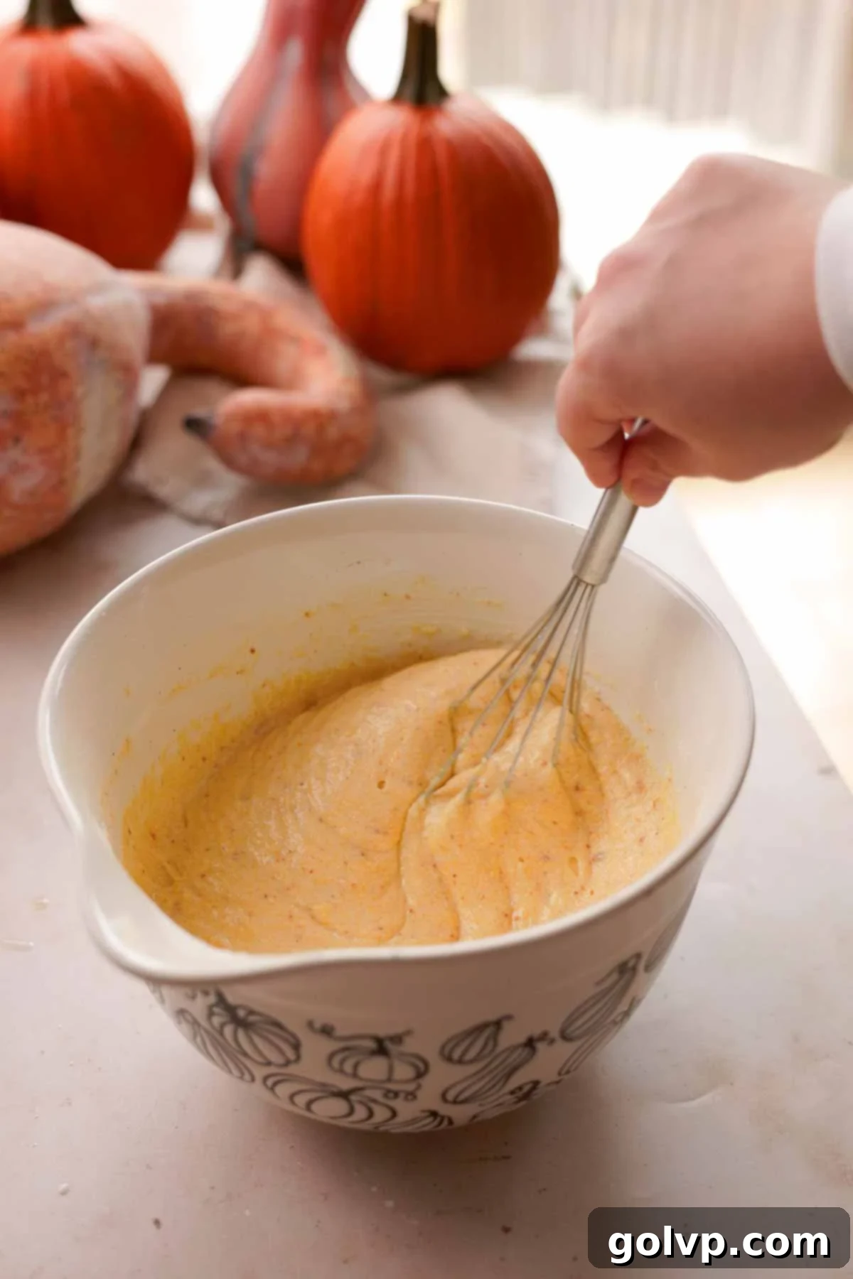 stirring cornbread batter with whisk