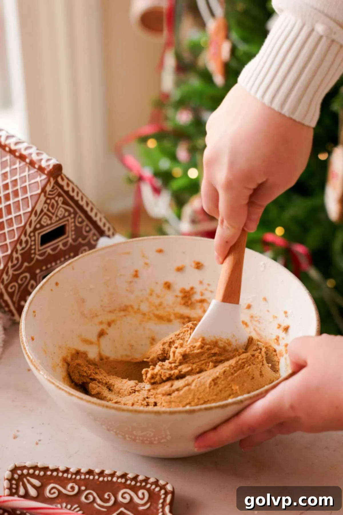 folding gingerbread cookie dough with spatula