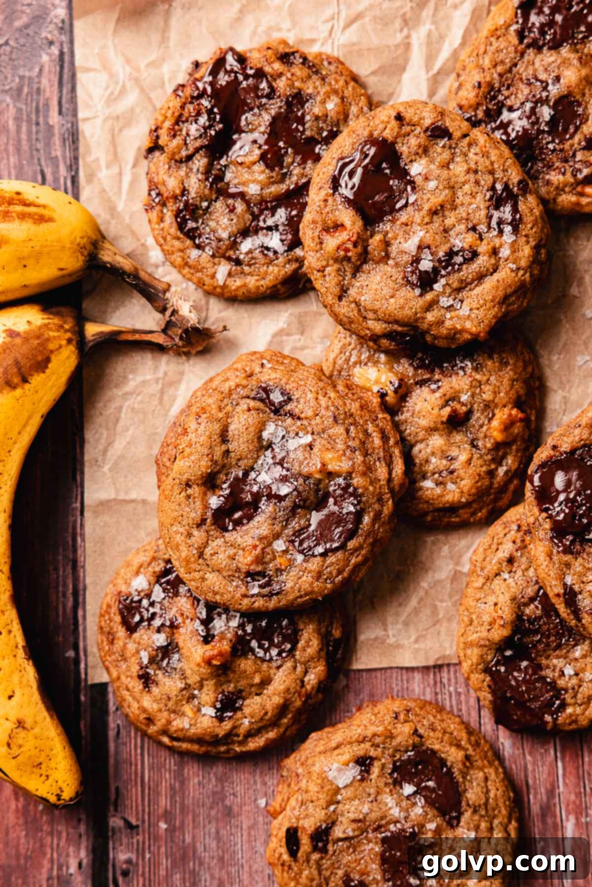 Soft-Baked Banana Bread Cookies 12 banana bread cookies with flaky salt on parchment paper