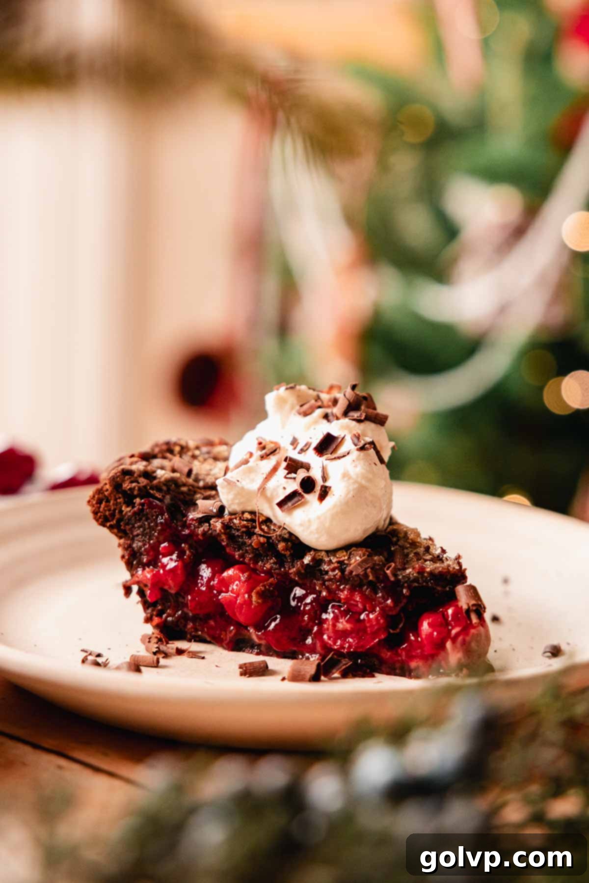 Decadent Chocolate Cherry Black Forest Pie 3 closeup of slice of chocolate cherry pie with whipped cream