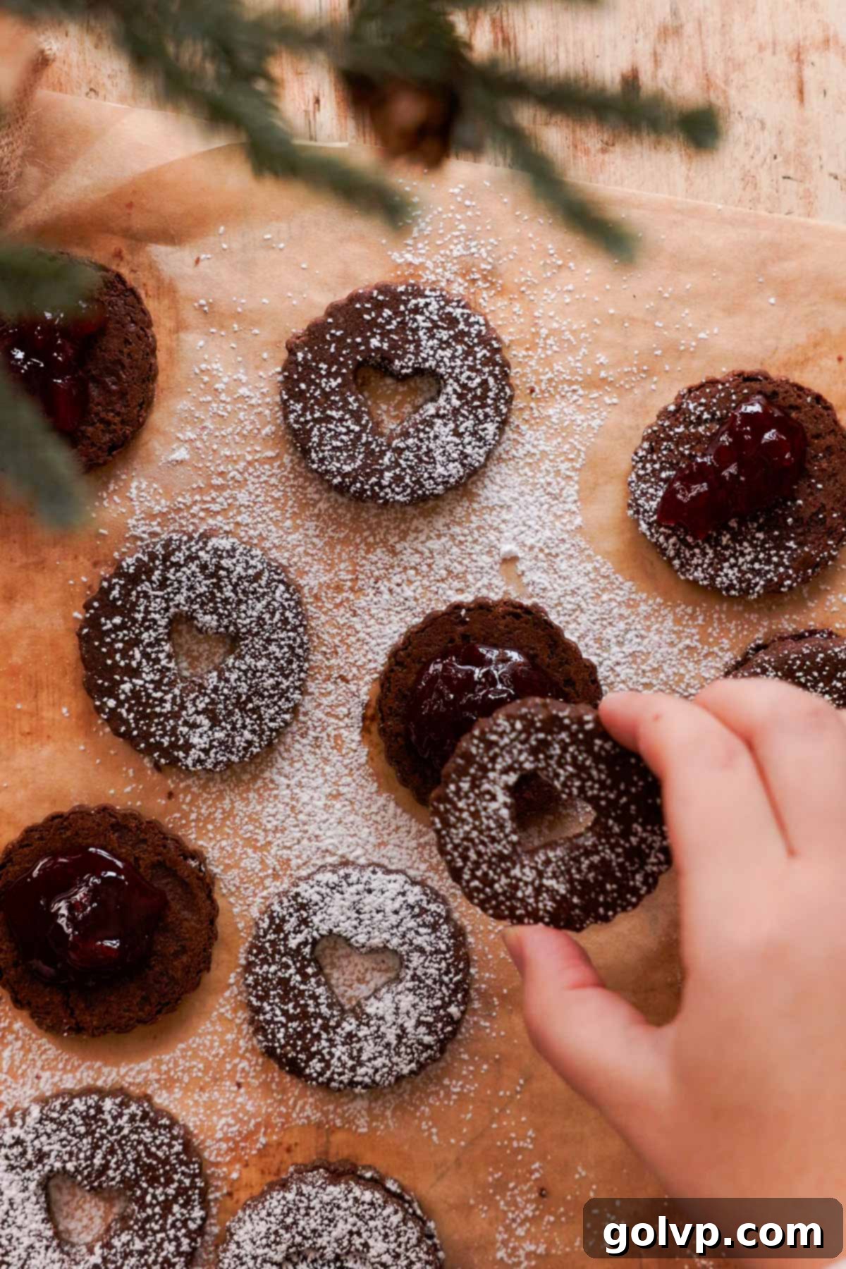 assembling chocolate cookies with cherry filling