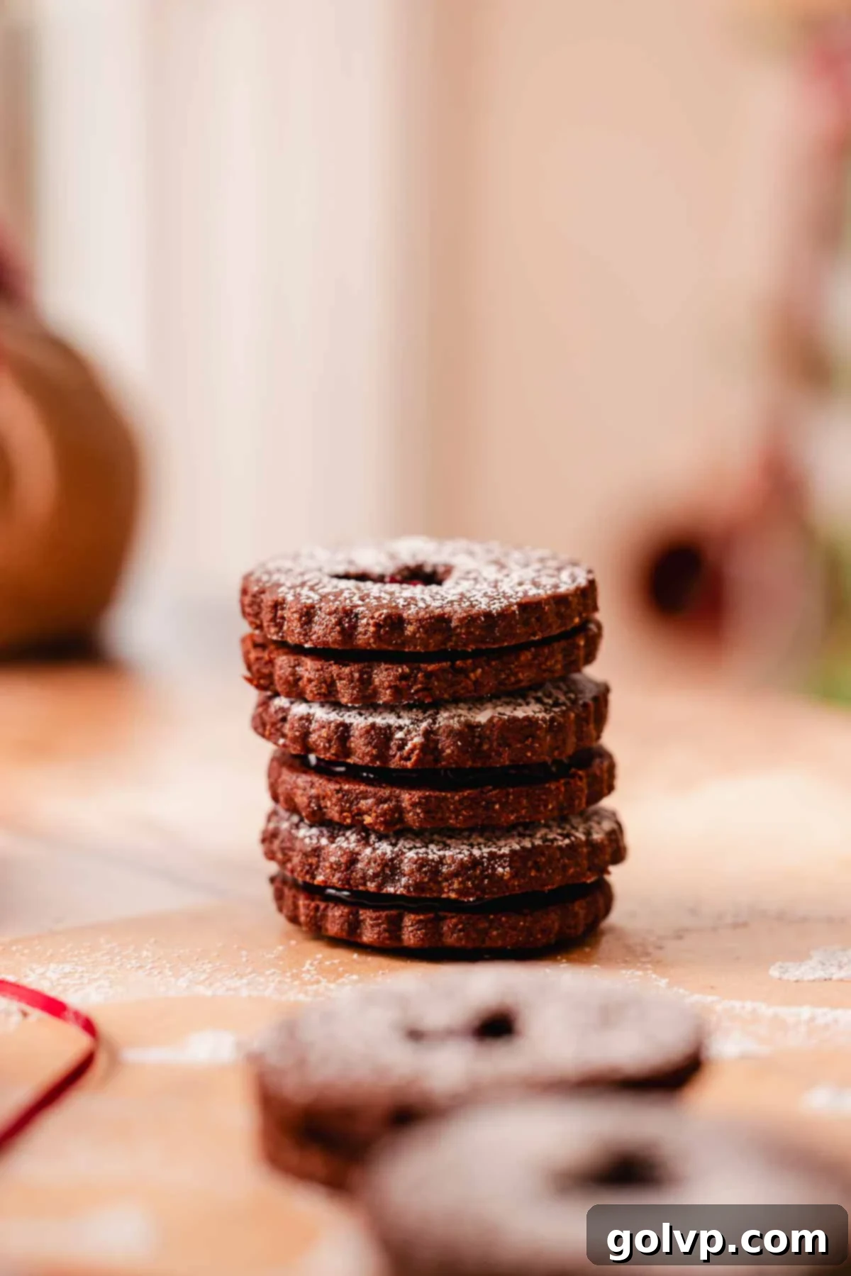 stack of chocolate cherry almond linzer cookies