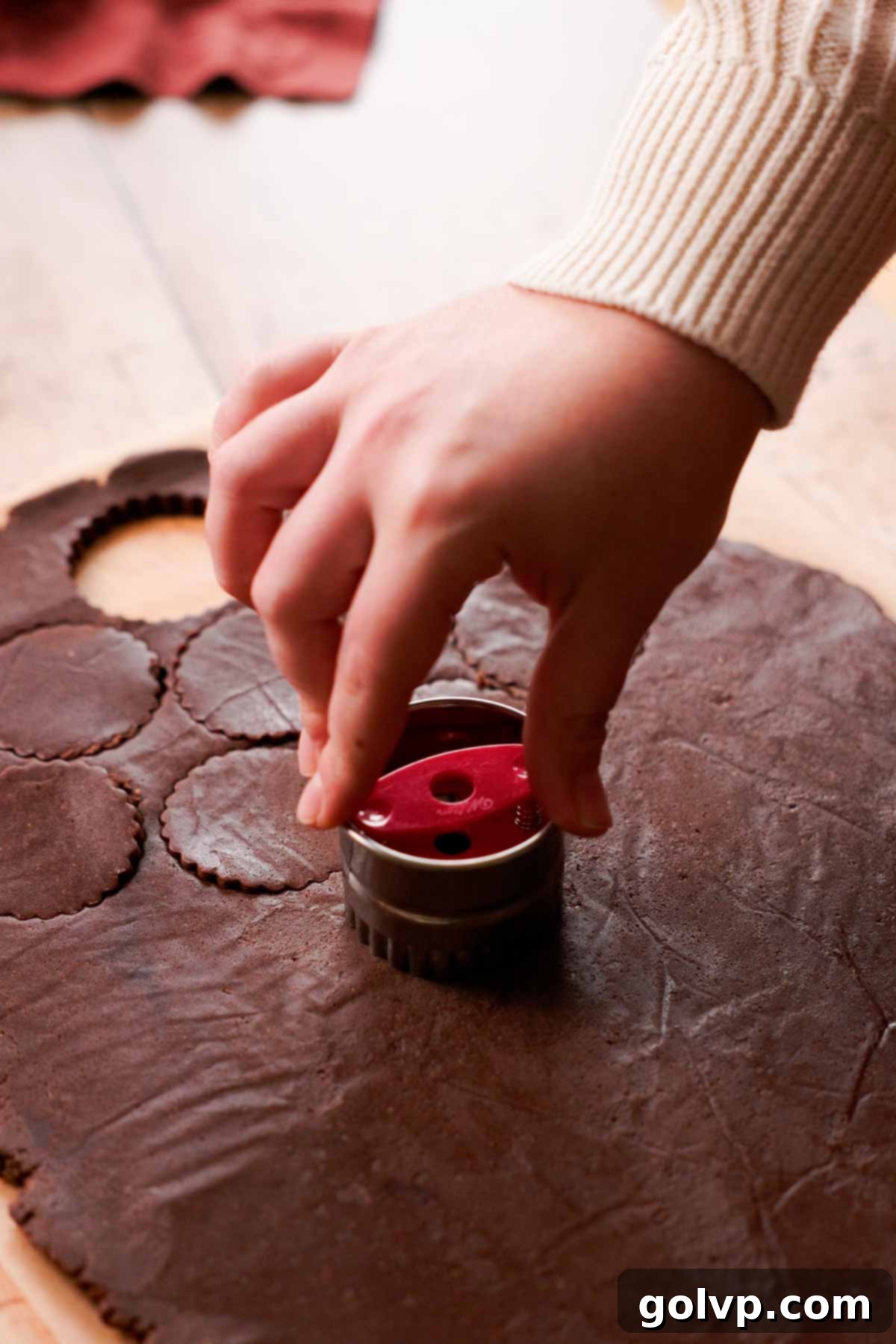 cutting out linzer almond cookies