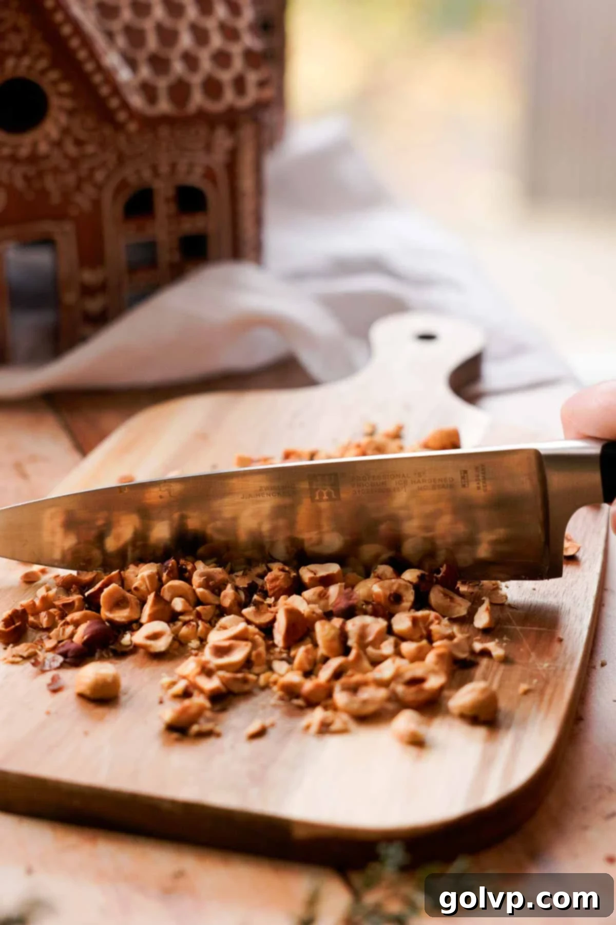 Irresistible Nutella Banana Bread 4 chopping roasted hazelnuts into small pieces on a cutting board
