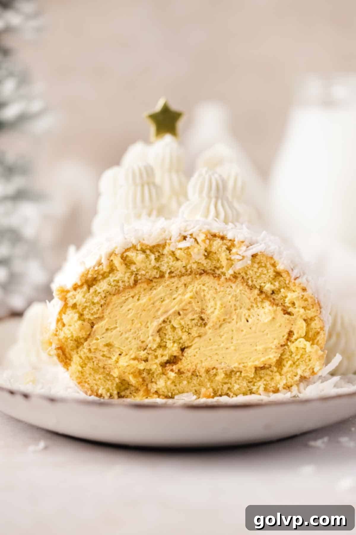 Elegant mango coconut Swiss roll cake with creamy mango mascarpone filling and shredded coconut topping, perfect for any celebration.