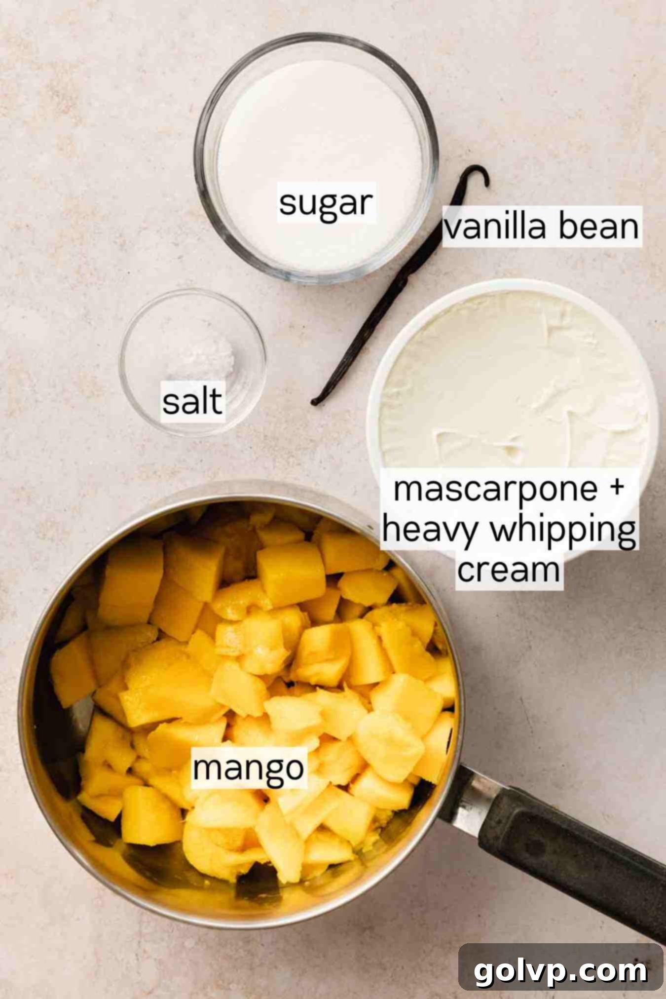 Diced mangoes, granulated sugar, and a whole vanilla bean, the core ingredients for a rich mango mascarpone filling.