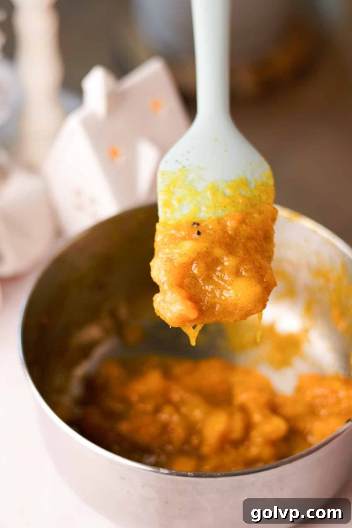 Thick, jammy cooked mango puree in a saucepan, ready for blending.