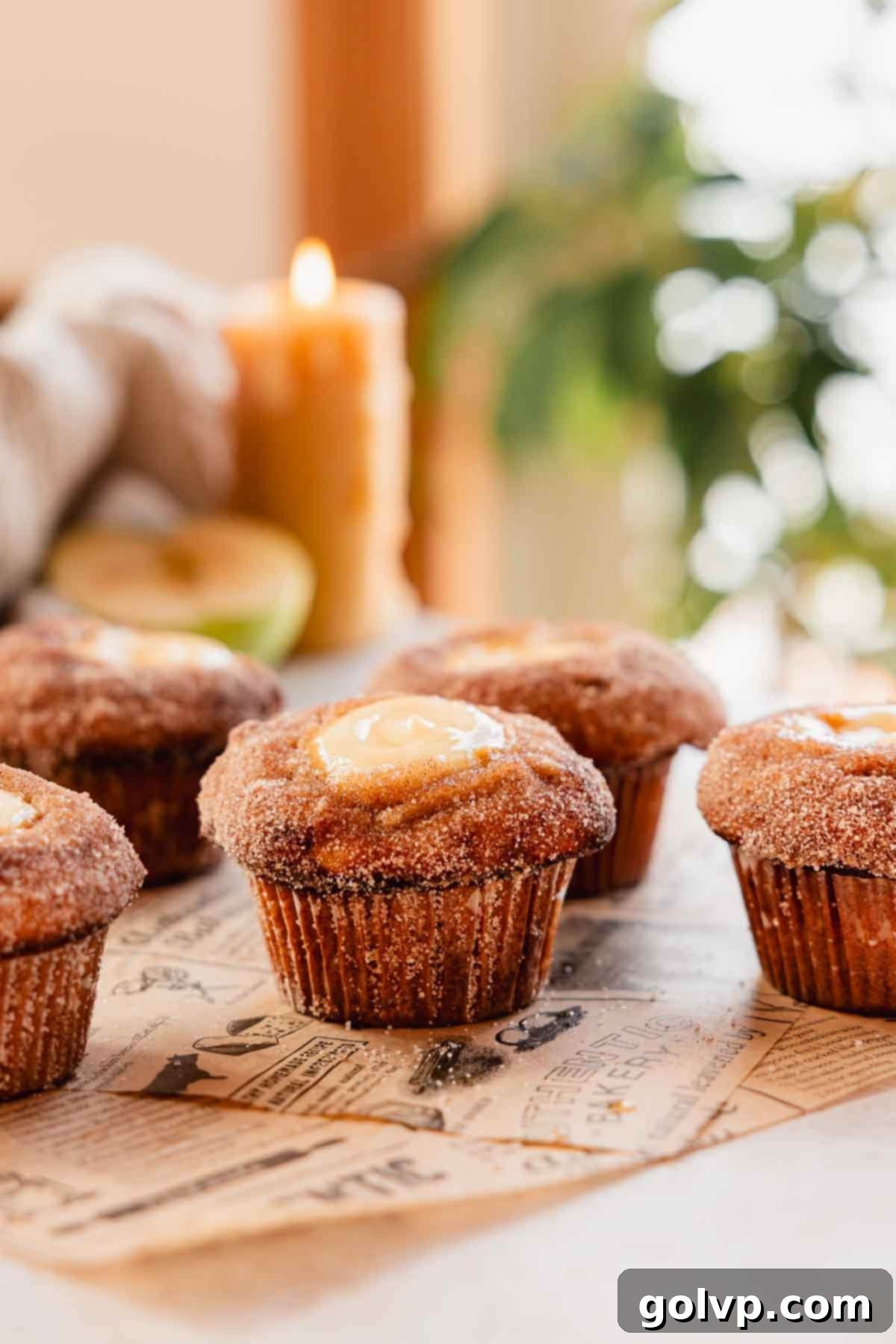 Freshly baked apple cider muffins arranged on parchment paper