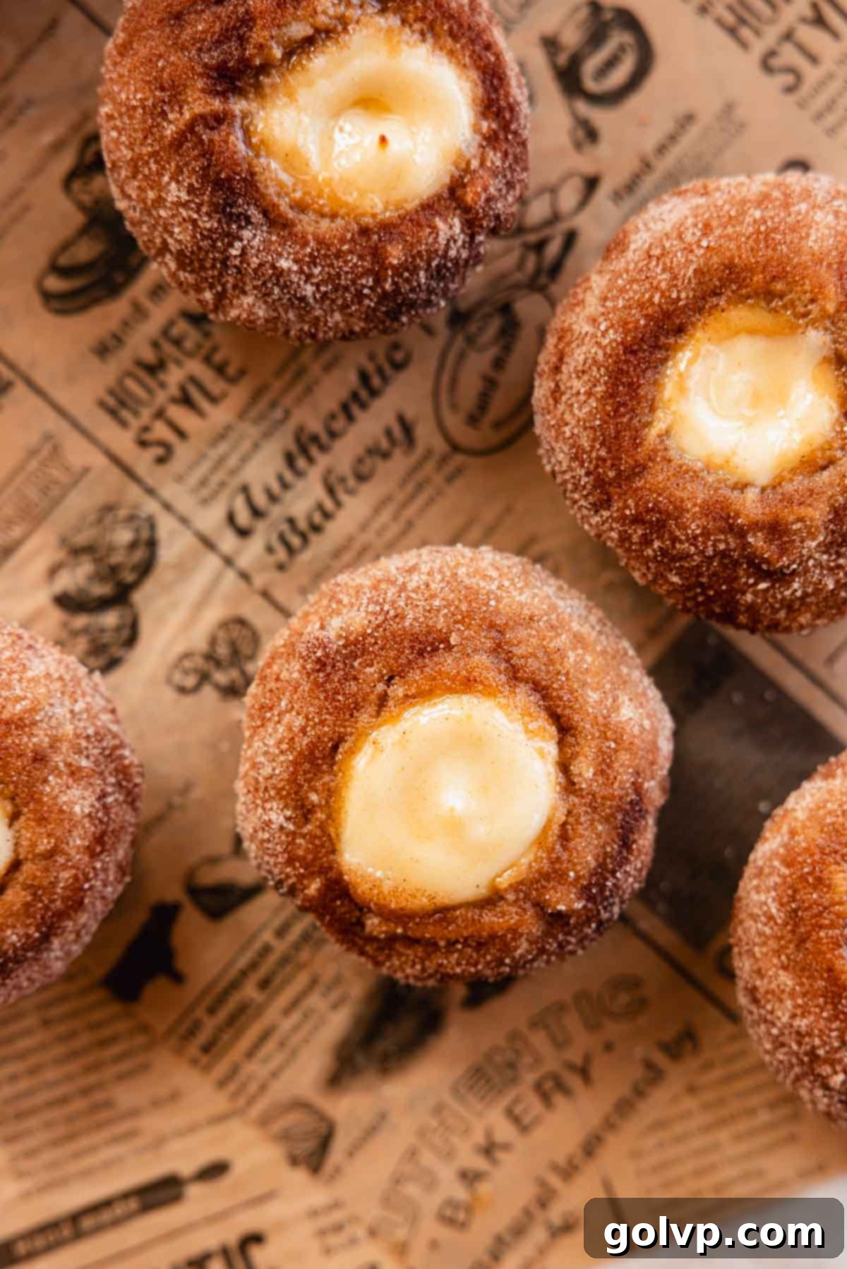 Close-up of apple cider muffins with cream cheese filling and cinnamon sugar, showing texture