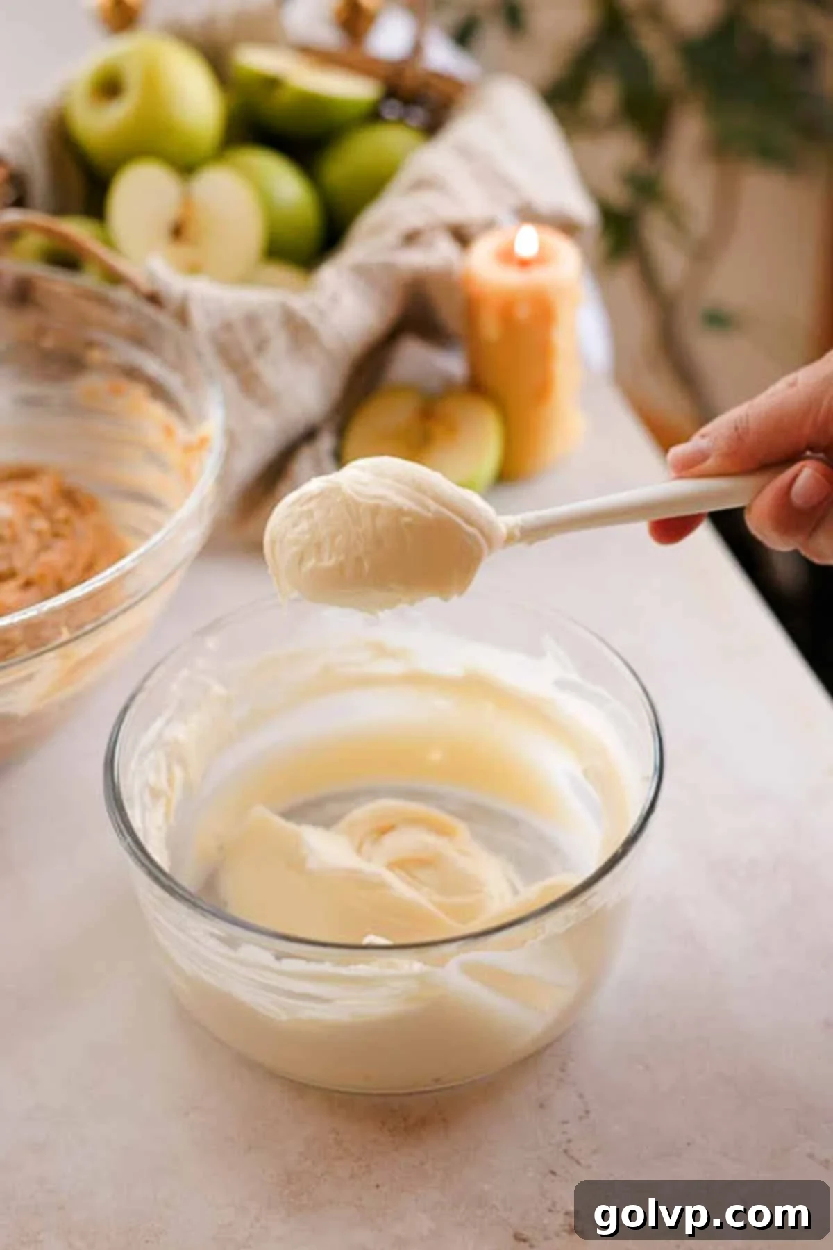 Cream cheese muffin filling on a spoon, showing its smooth consistency