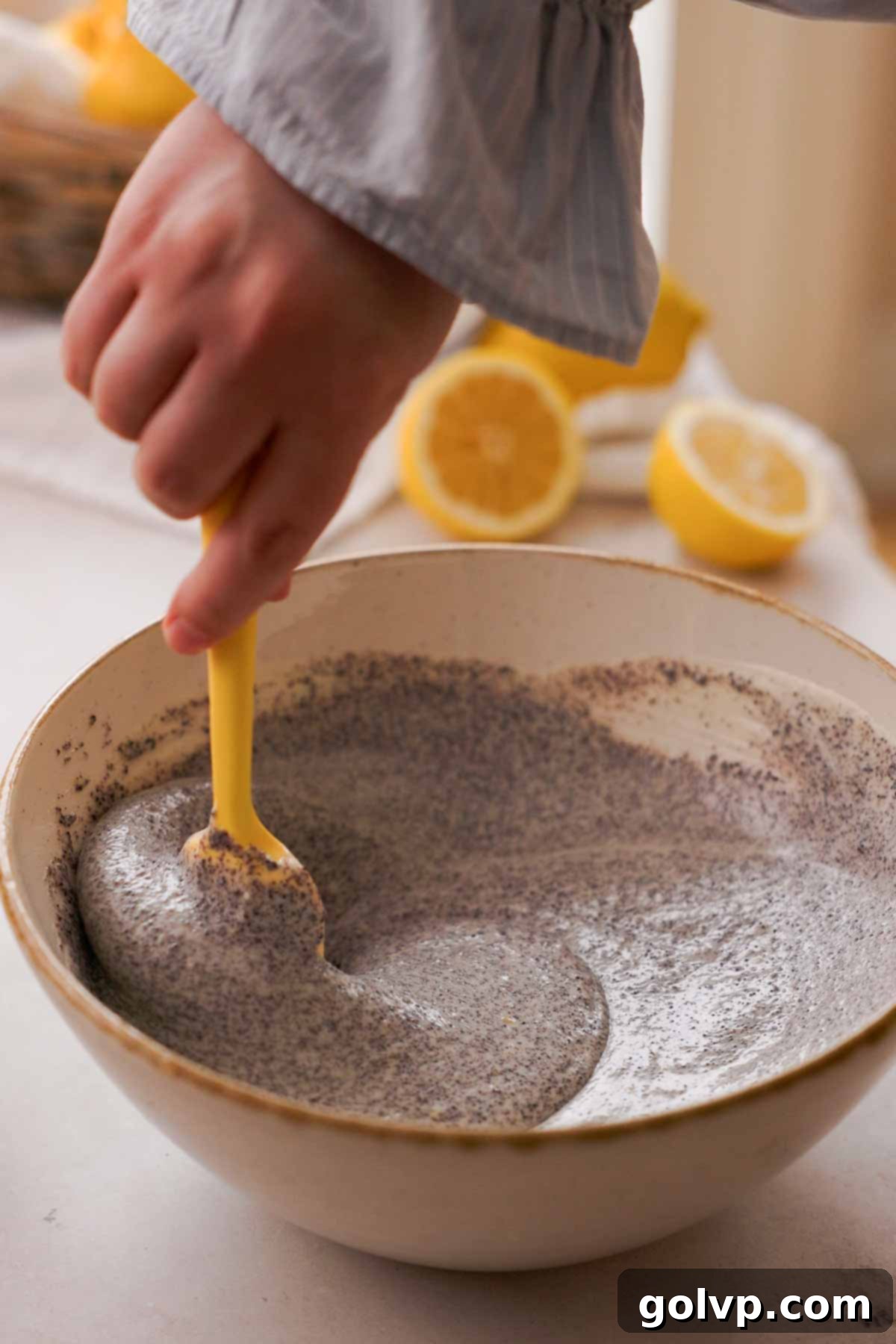 Lemon Poppy Seed Cheesecake Perfection 13 stirring poppy seed cheesecake batter with silicone spatula