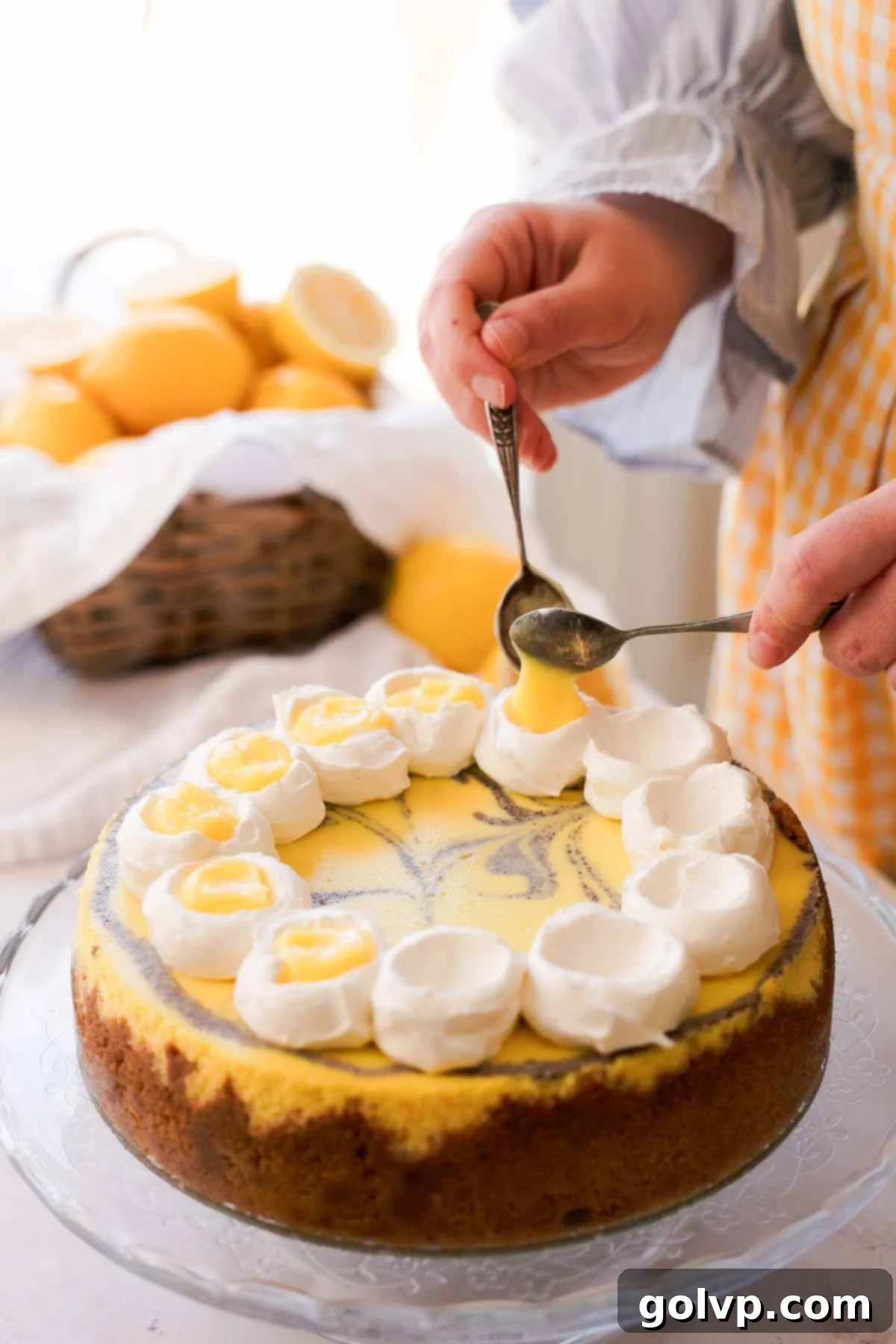 Lemon Poppy Seed Cheesecake Perfection 19 spooning lemon curd on top of lemon poppy seed cheesecake