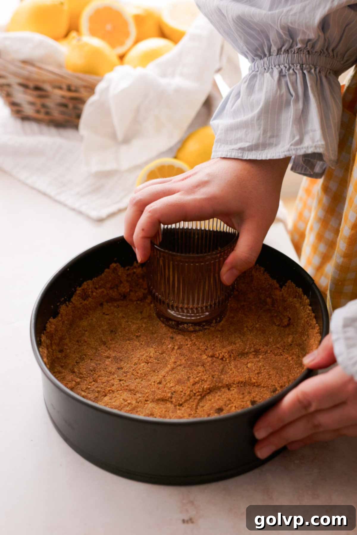 Lemon Poppy Seed Cheesecake Perfection 6 pressing in cheesecake crust into cake pan
