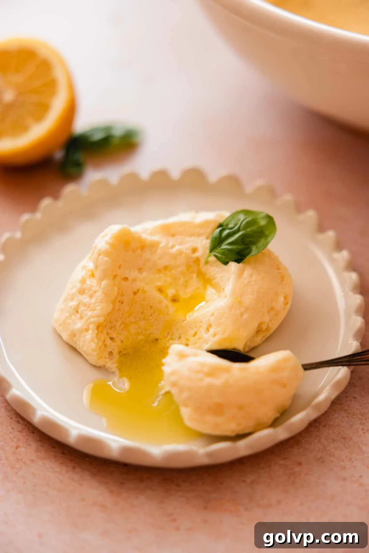 served scoop of lemon mousse with olive oil drizzle