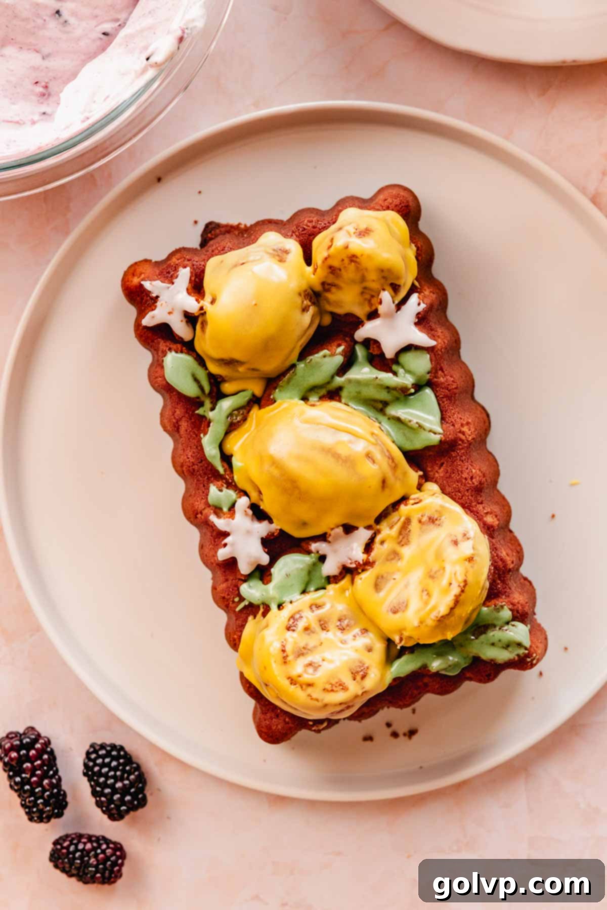 glazed lemon pound cake baked in a decorative Nordicware loaf pan