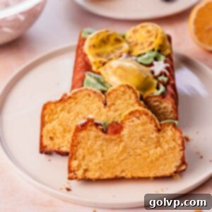 moist slices of lemon pound cake on a plate with fresh blackberries