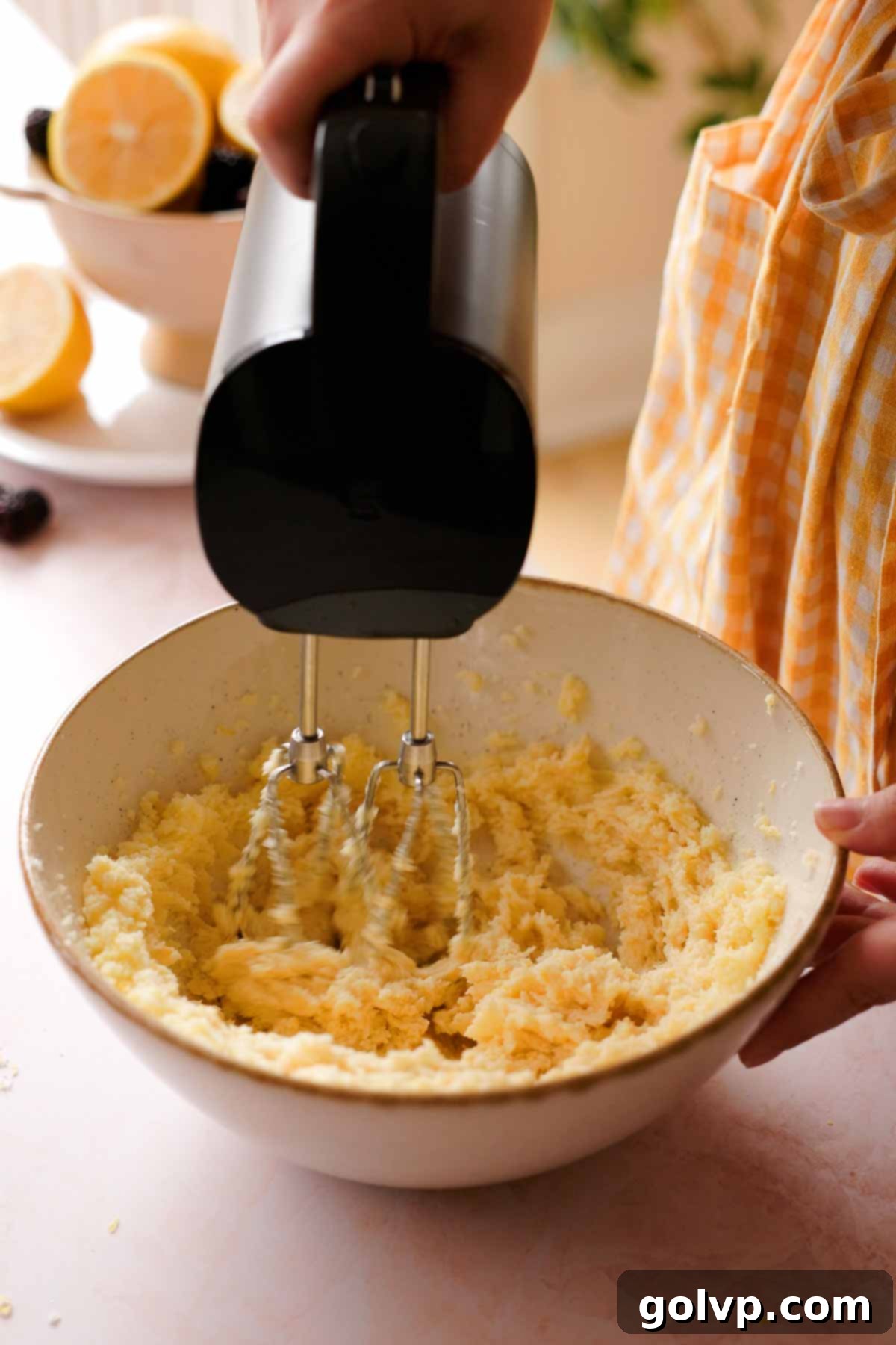 creaming softened butter and lemon-infused sugar with an electric mixer until light and fluffy