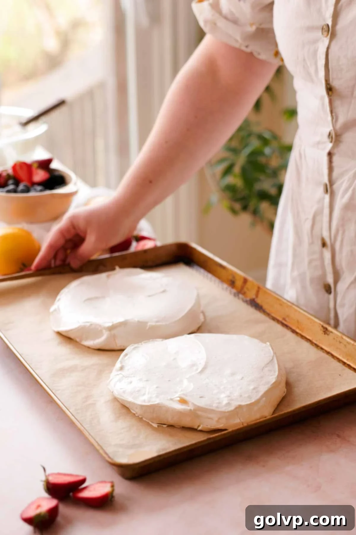 two baked pavlova layers on parchment paper