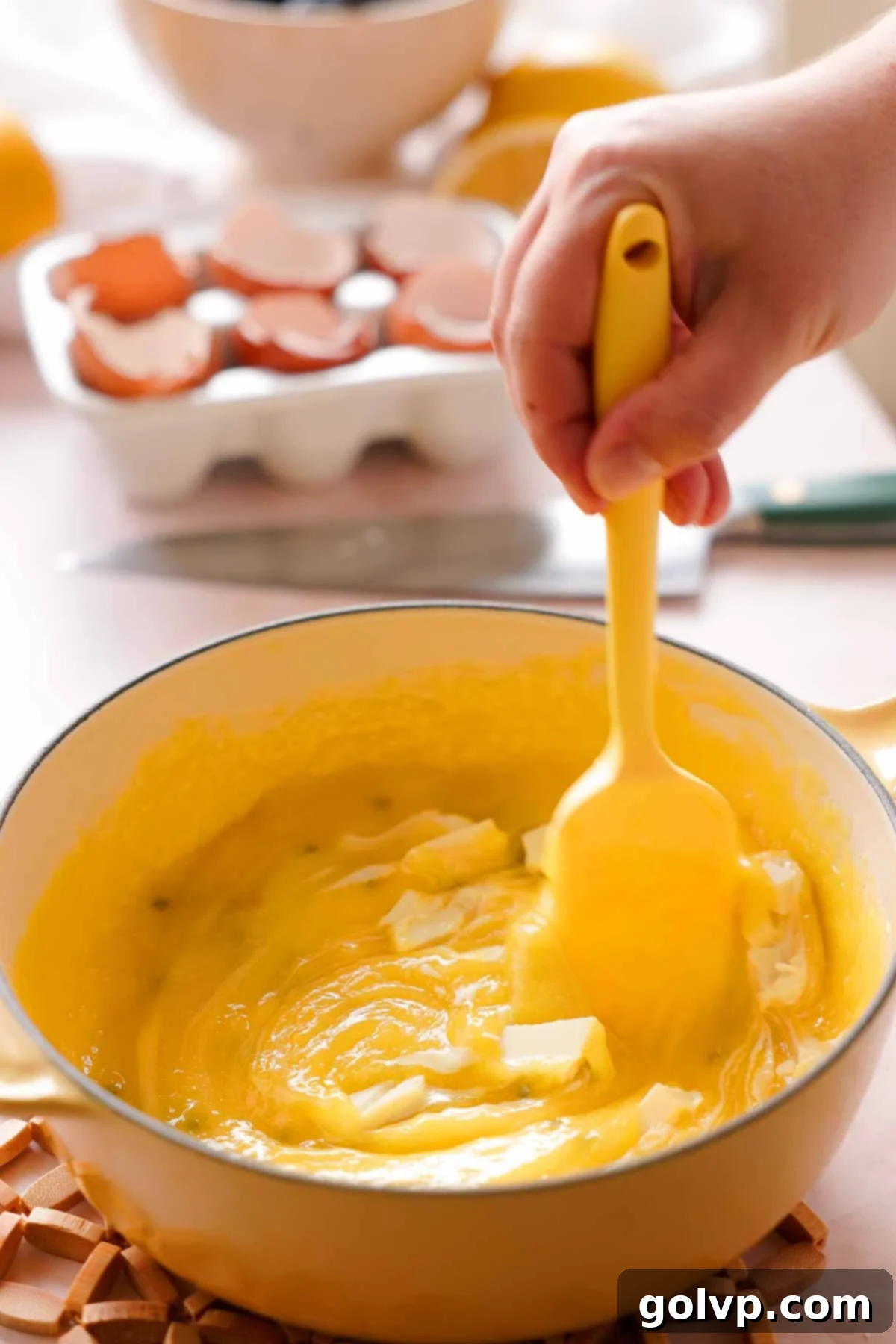 stirring white chocolate into cooked lemon passion fruit curd