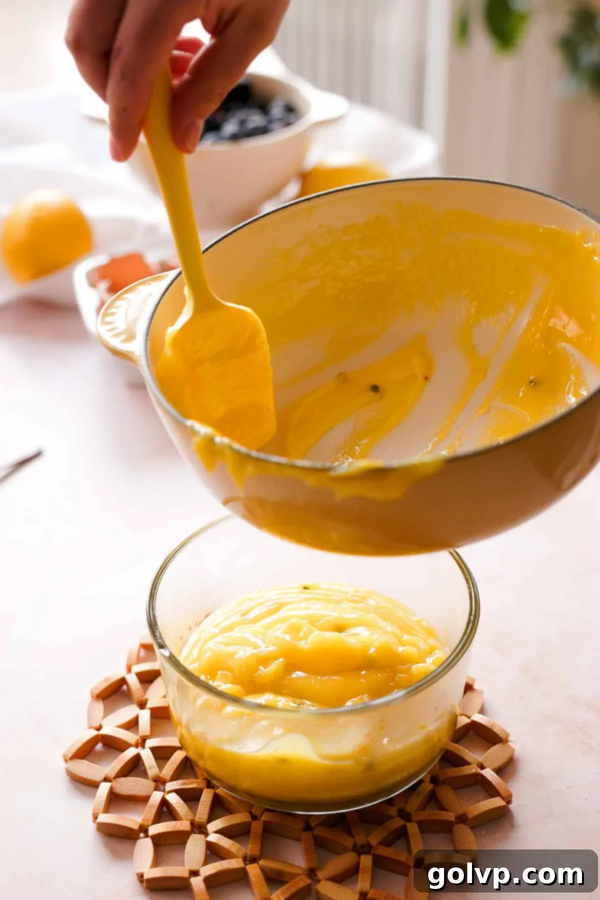 transferring passion fruit curd into glass container