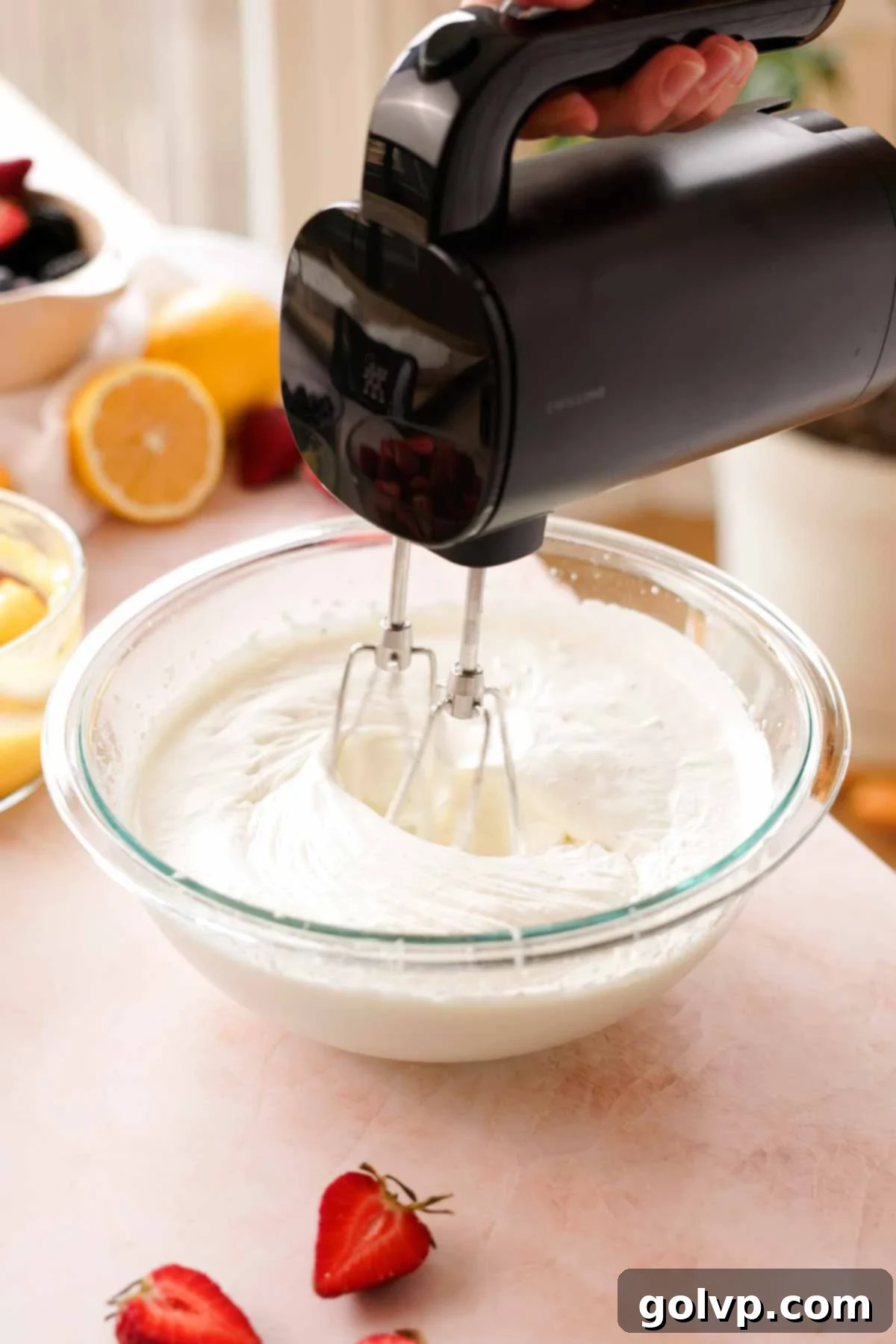 whipping cream to soft peaks in glass bowl