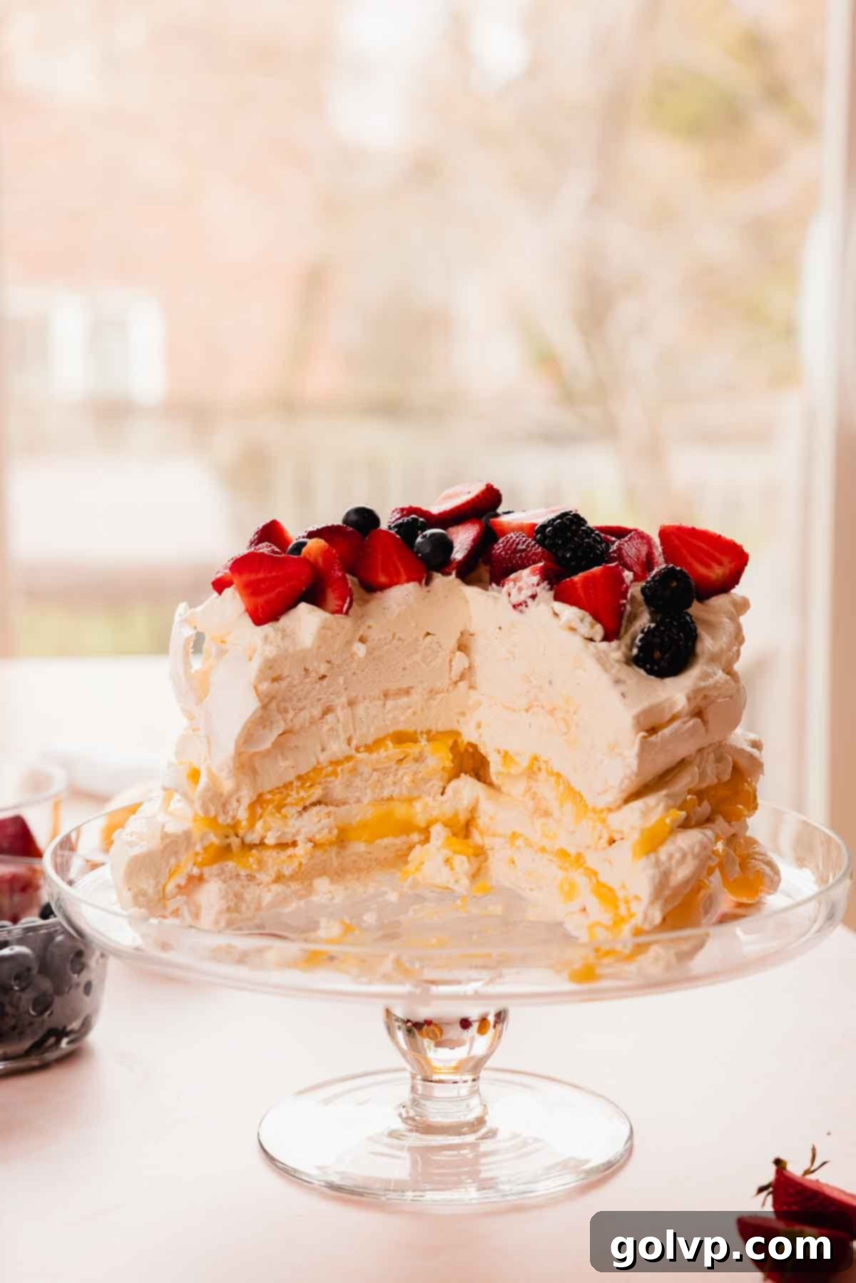 layered stacked pavlova cake with passion fruit lemon curd cut inside