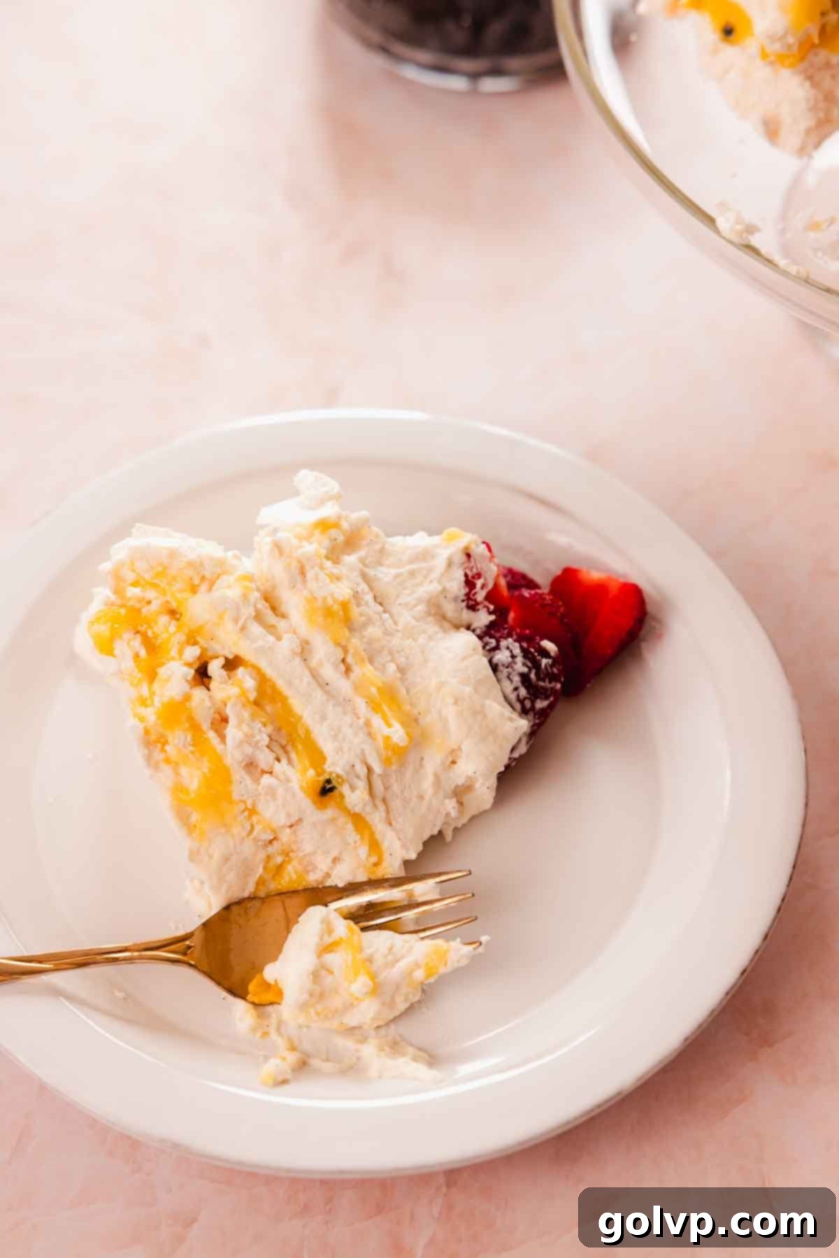slice of pavlova layered cake with berries on a plate