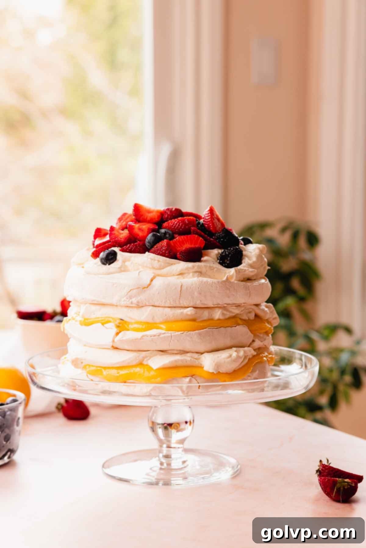 pavlova layer cake with berries and lemon passion fruit curd