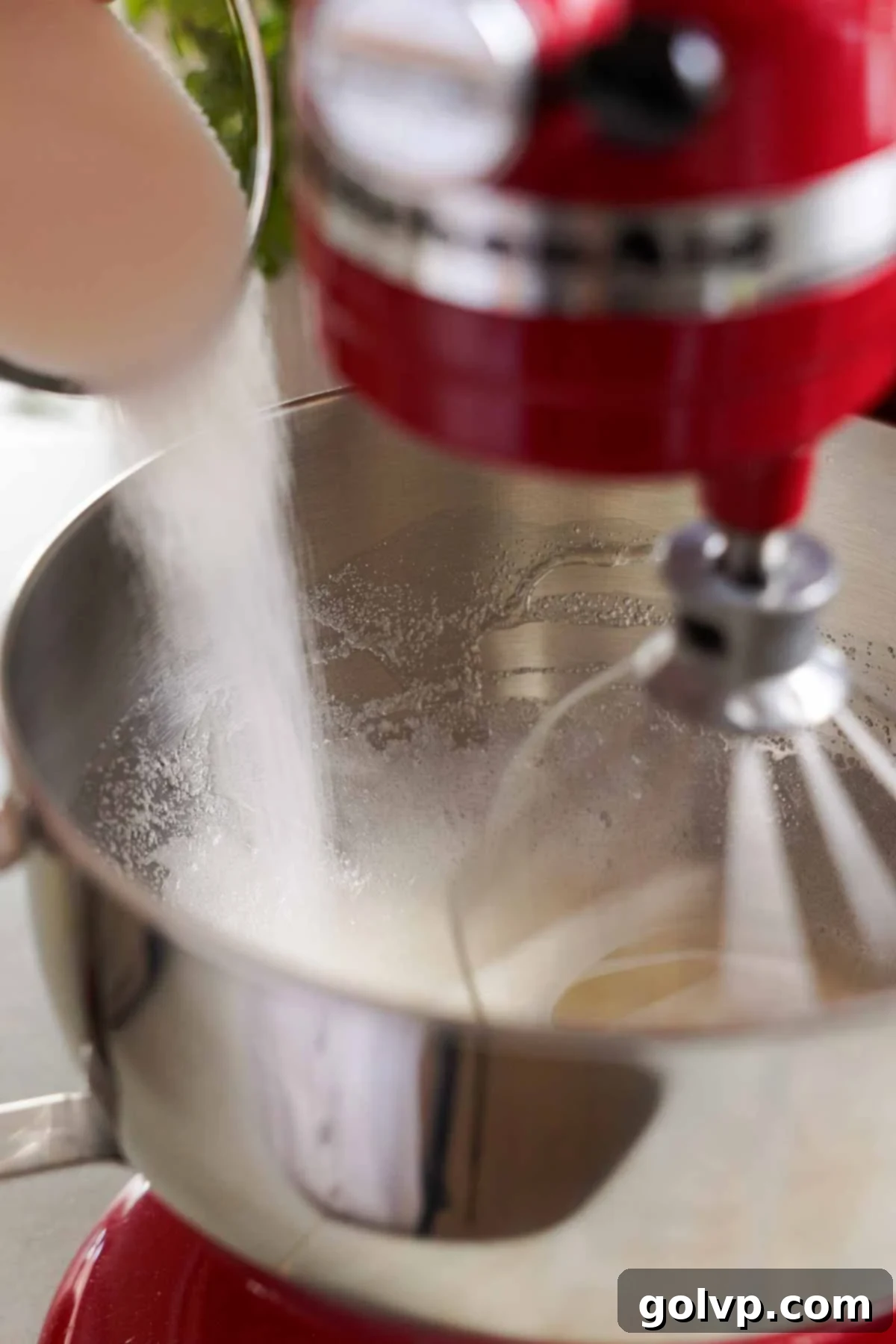 adding sugar gradually into egg whites in stand mixer